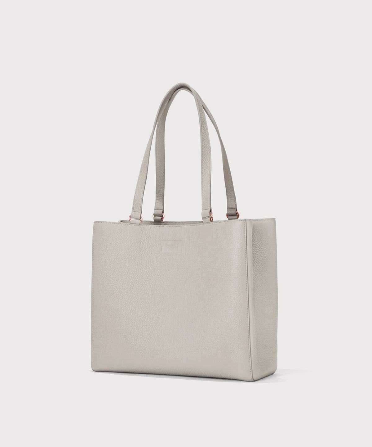 Dagne Dover medium Allyn Tote in light grey seen from an angle.
