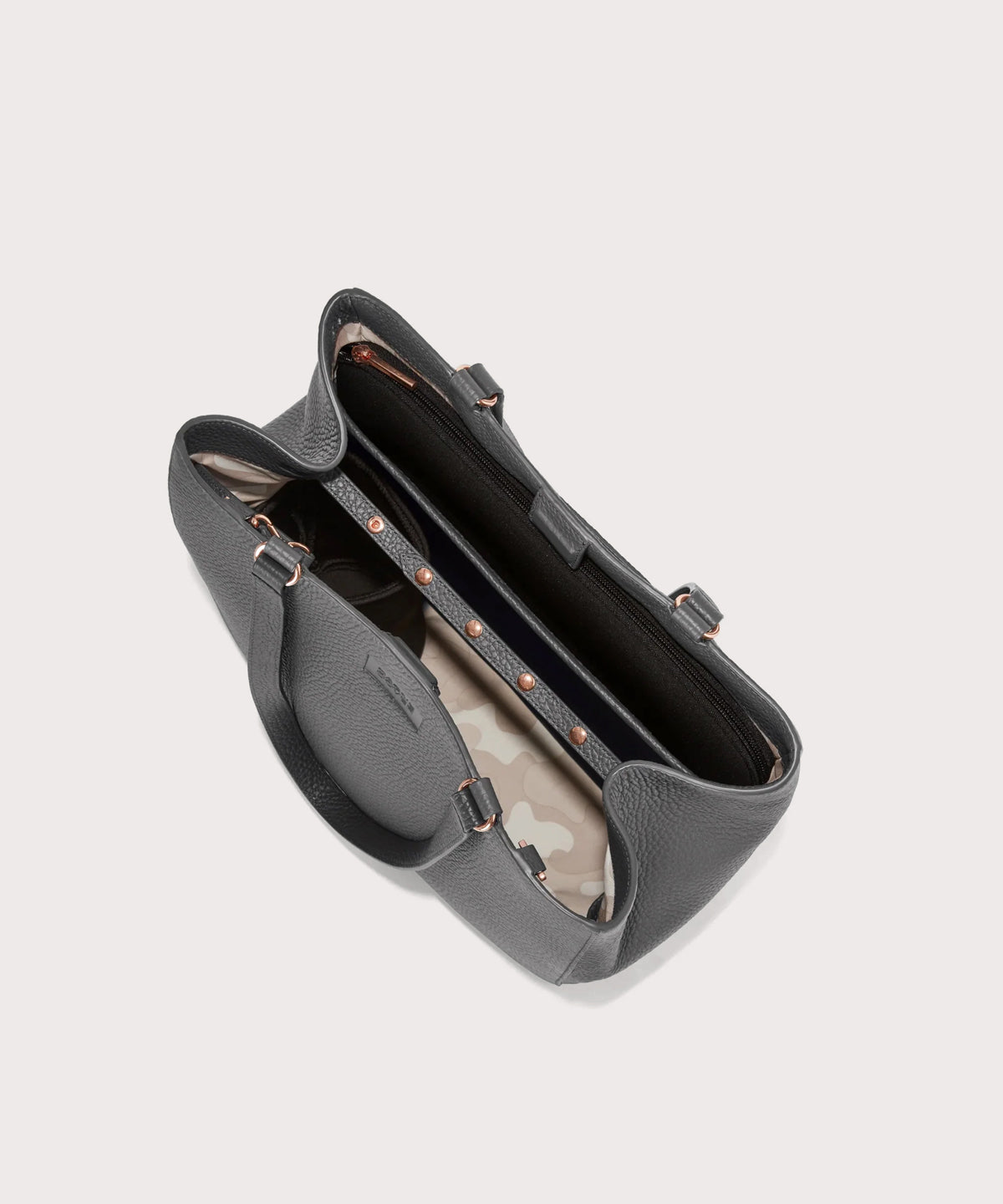 Dagne Dover medium Allyn Tote in grey with objects inside the interior pockets.
