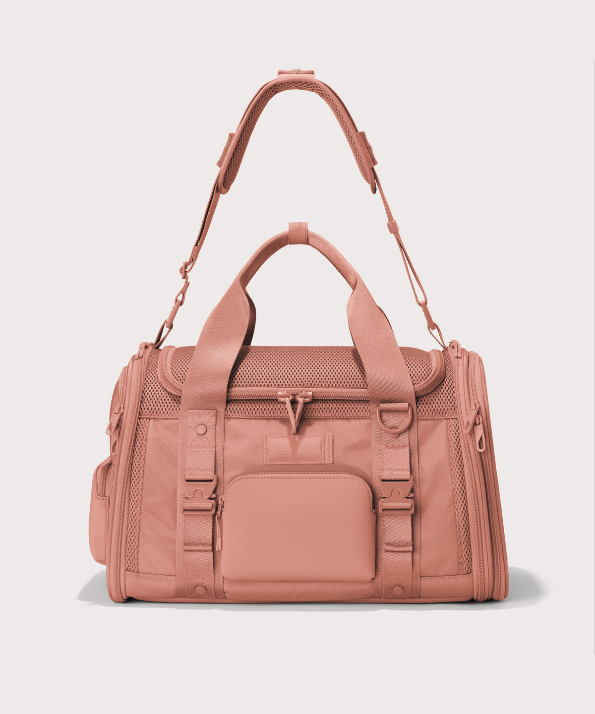 Dagne Dover Large Kyoto Pet Carrier in a warm dust pink seen from the front with crossbody strap.
