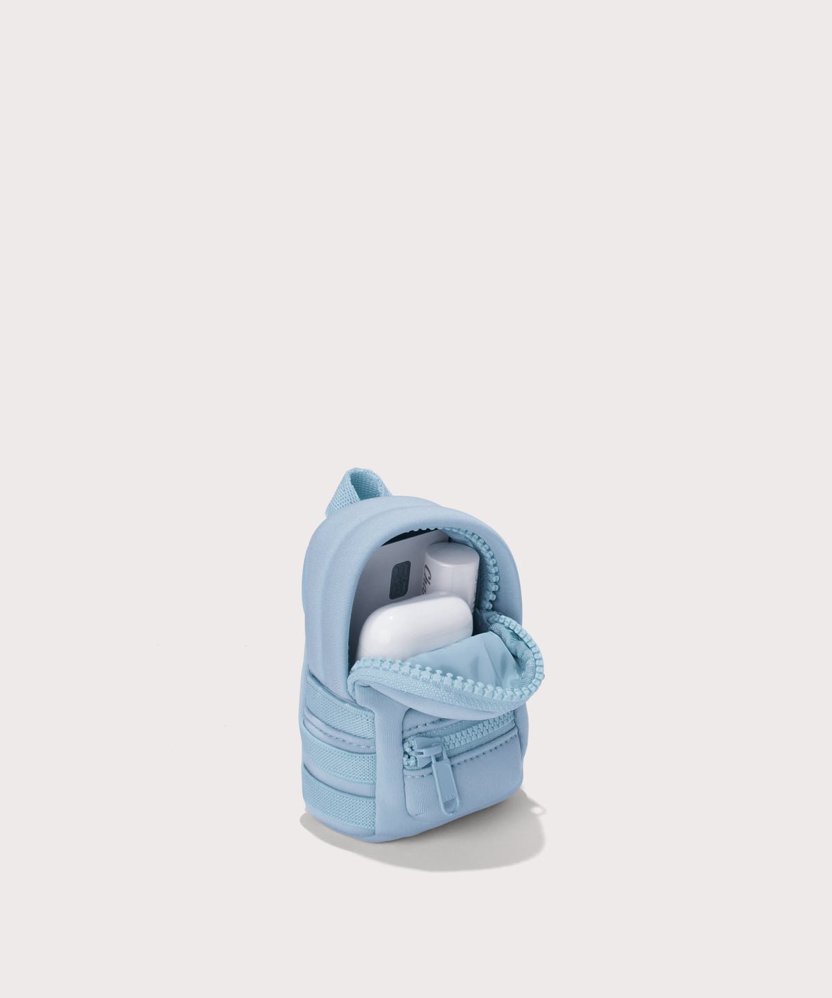 Dagne Dover Dakota Keychain in an airy, lighter sky blue unzipped, showing interior.