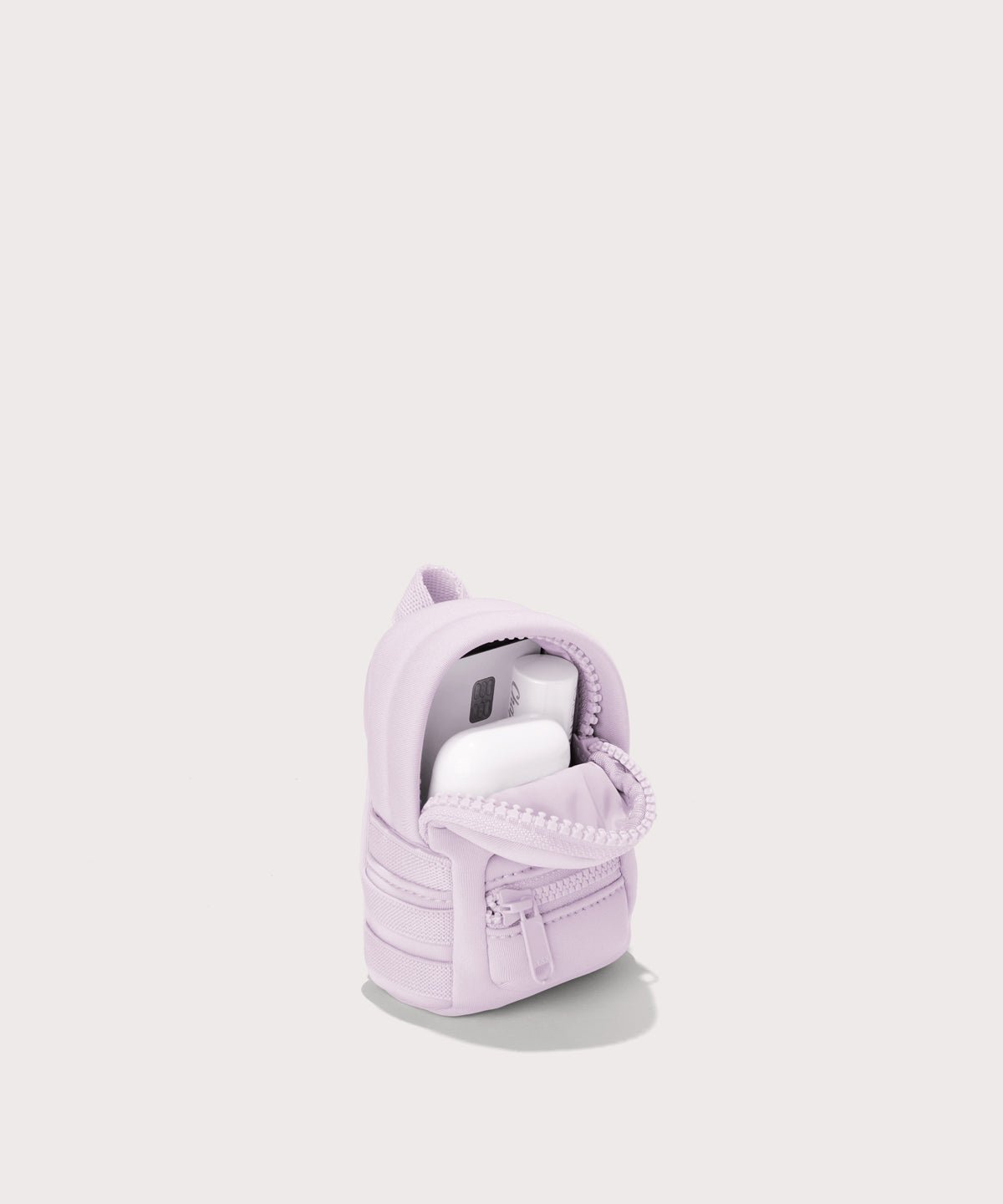 Dagne Dover Dakota Keychain in a soft purple with grey undertones unzipped, showing interior.