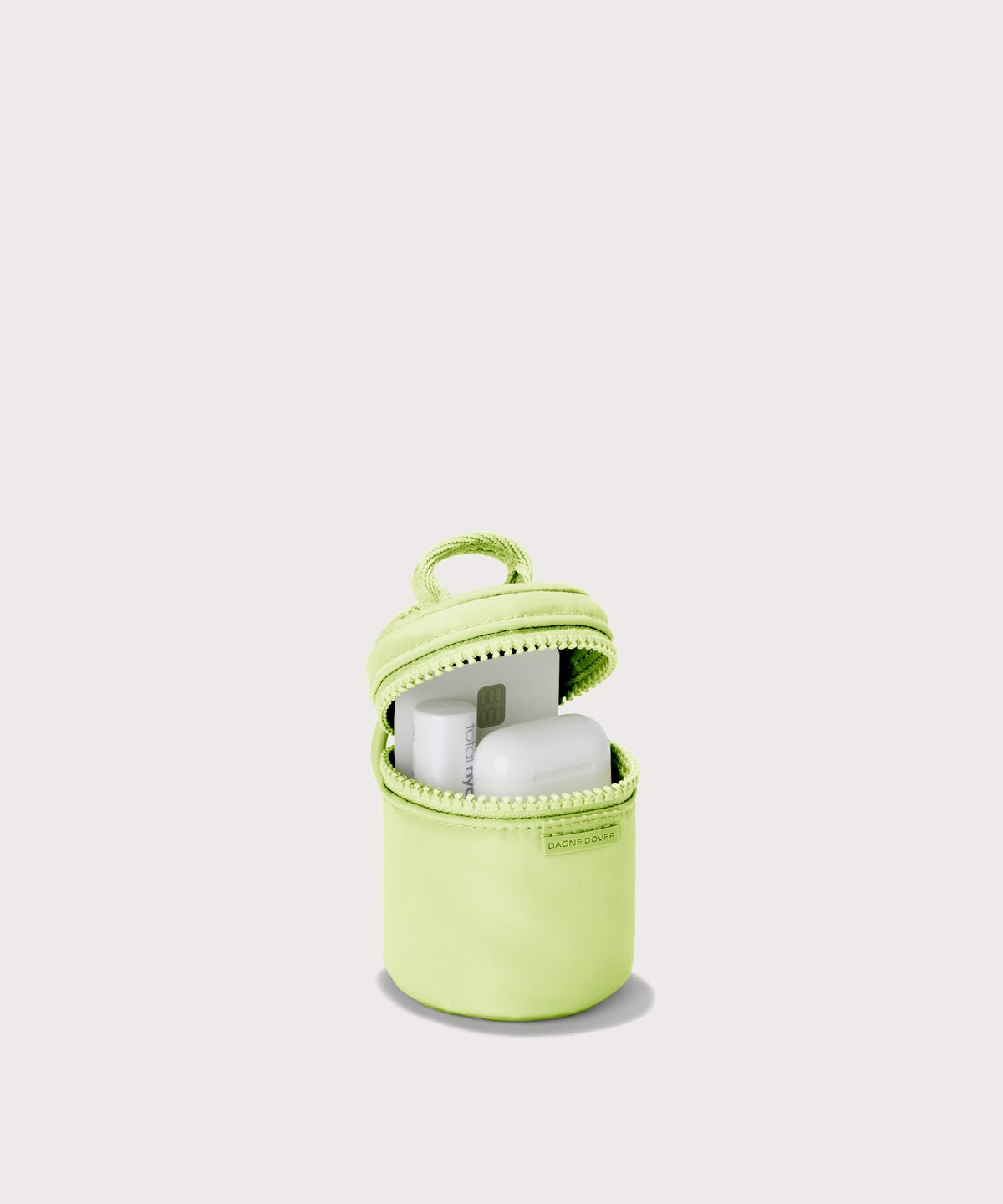 Dagne Dover Mila Keychain in a a vibrant, creamy green unzipped, showing interior.
