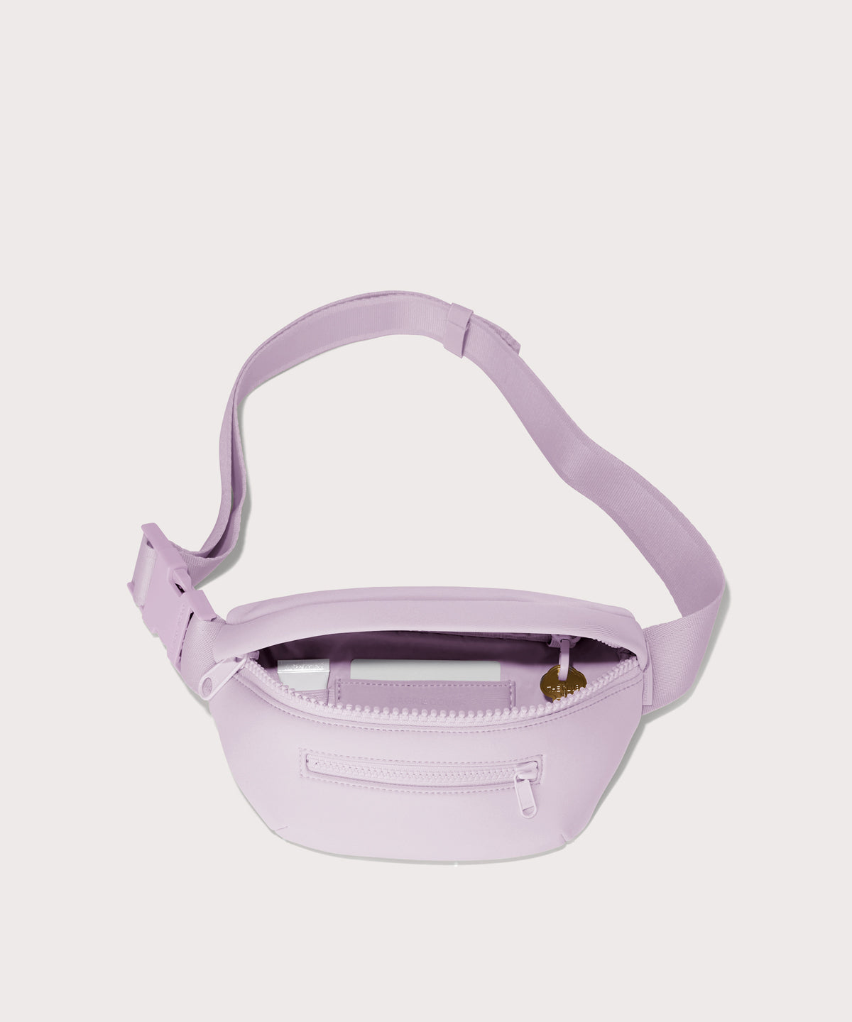 Dagne Dover Ace Fanny Pack in  a soft purple with grey undertones  unzipped, exposing the interior pockets. hover
