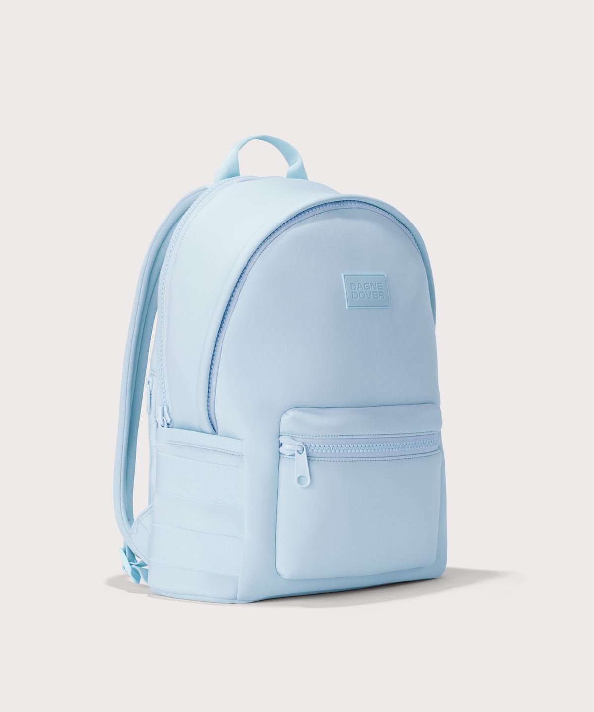 Dagne Dover large Dakota Neoprene Backpack in an airy, lighter sky blue seen from an angle.
