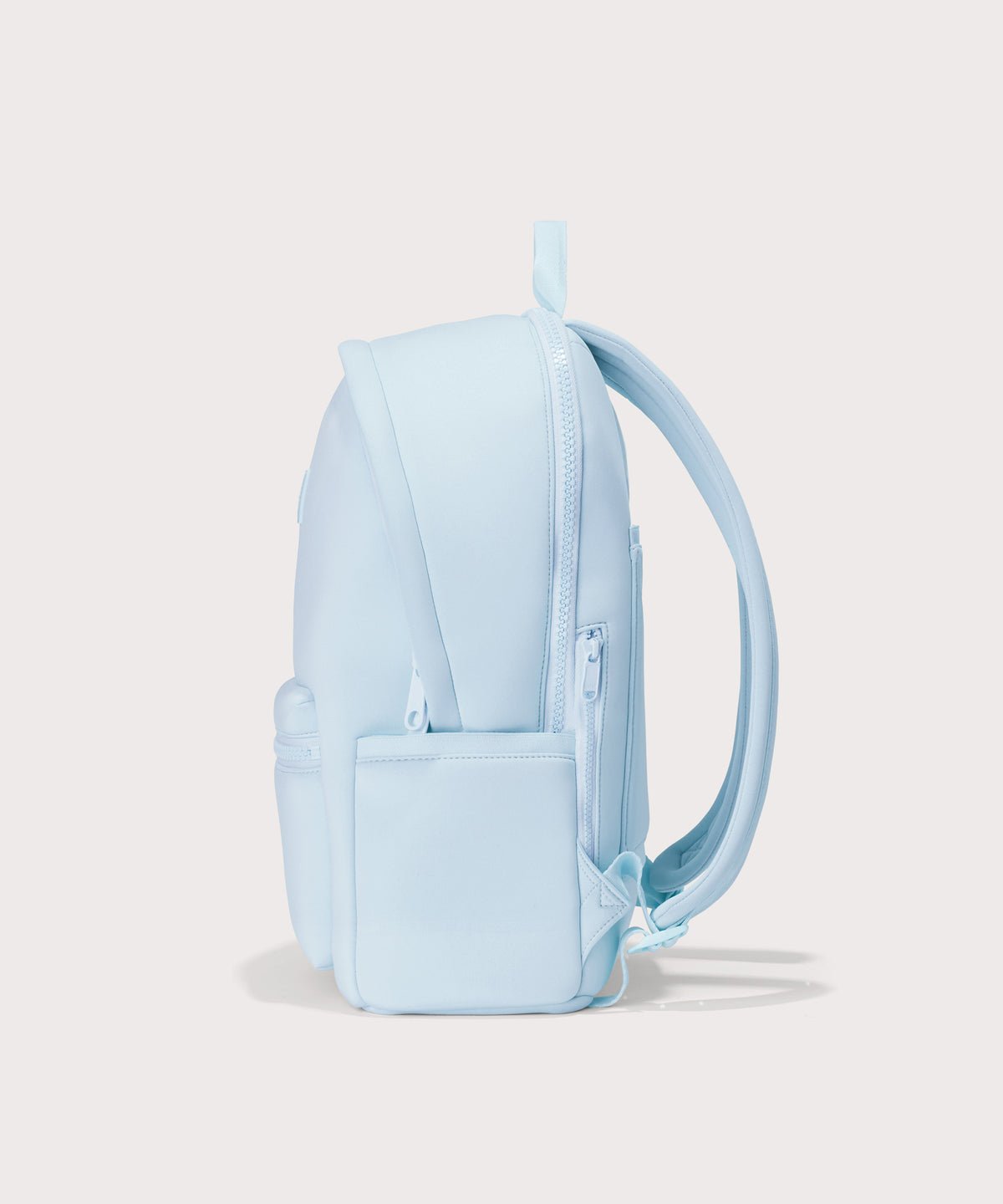 Dagne Dover large Dakota Neoprene Backpack in an airy, lighter sky blue seen from the side.
