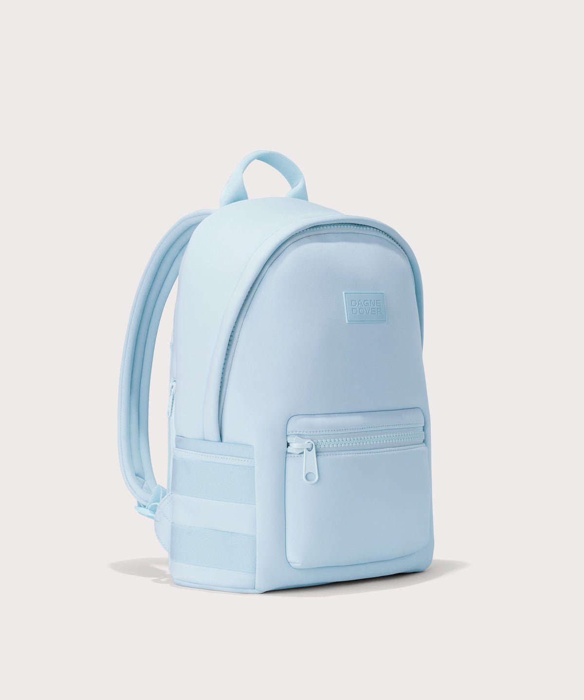 Dagne Dover medium Dakota Neoprene Backpack in an airy, lighter sky blue seen from an angle.
