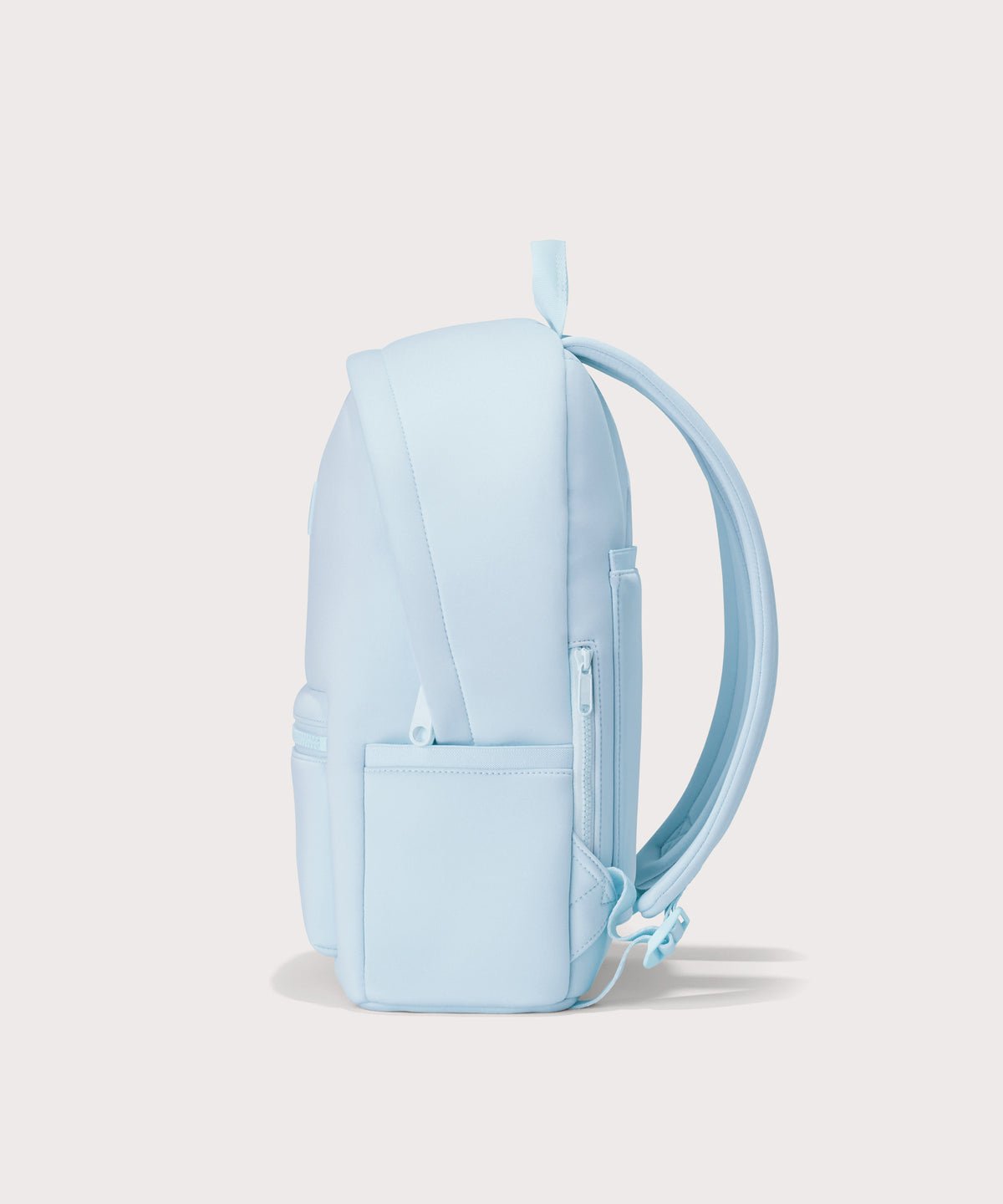 Dagne Dover medium Dakota Neoprene Backpack in an airy, lighter sky blue seen from the side.
