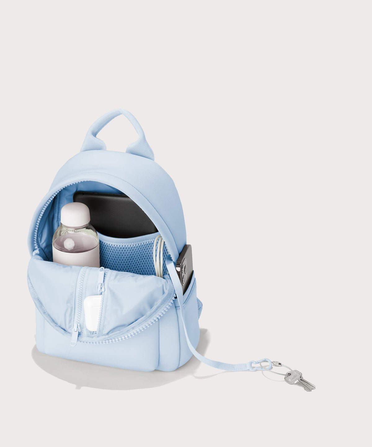 Dagne Dover Dakota Small Neoprene Backpack in a airy, lighter sky blue  unzipped, revealing the interior air mesh pockets.