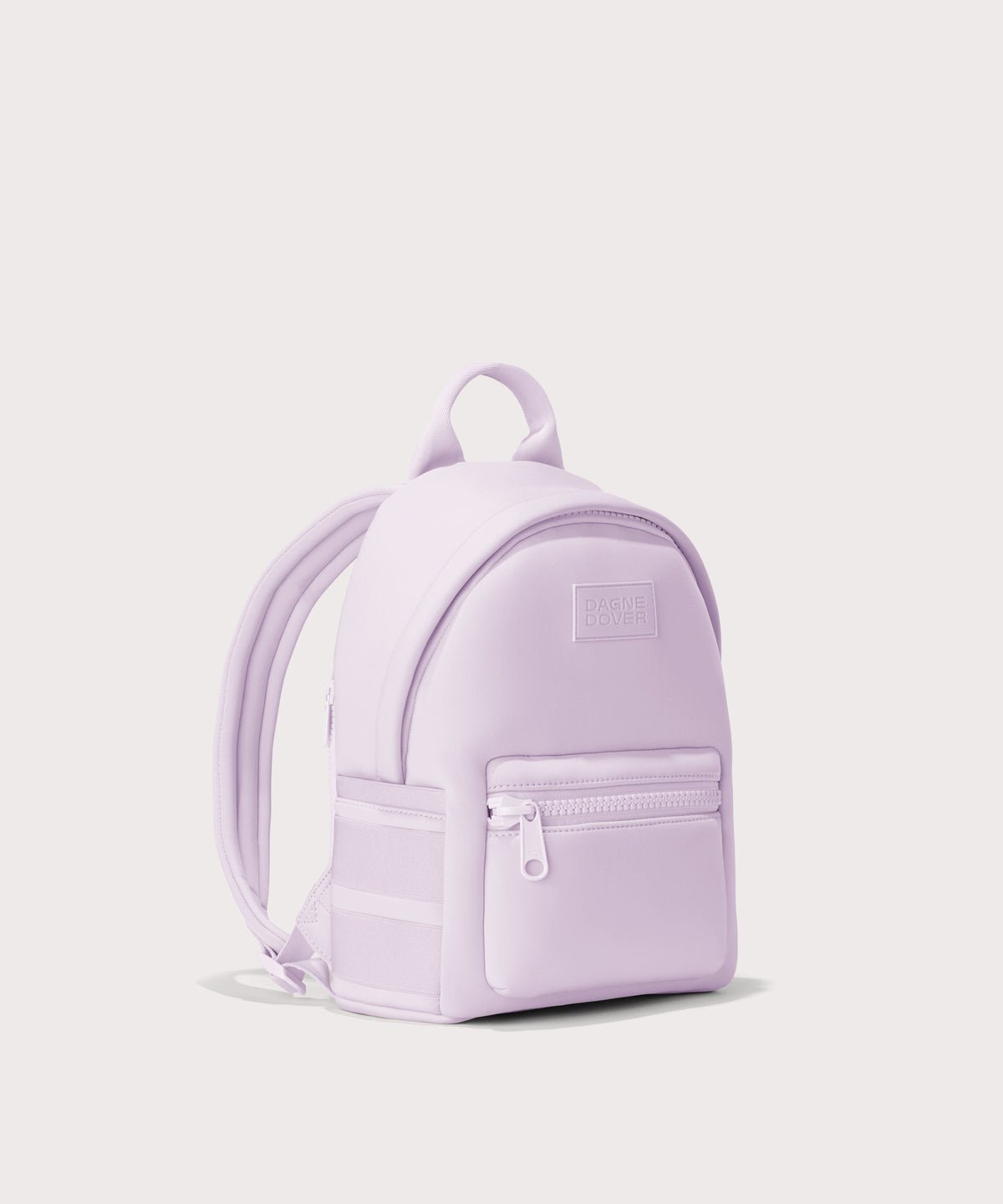 Dagne Dover small Dakota Neoprene Backpack in a soft purple with grey undertones seen from an angle. seen from an angle.
