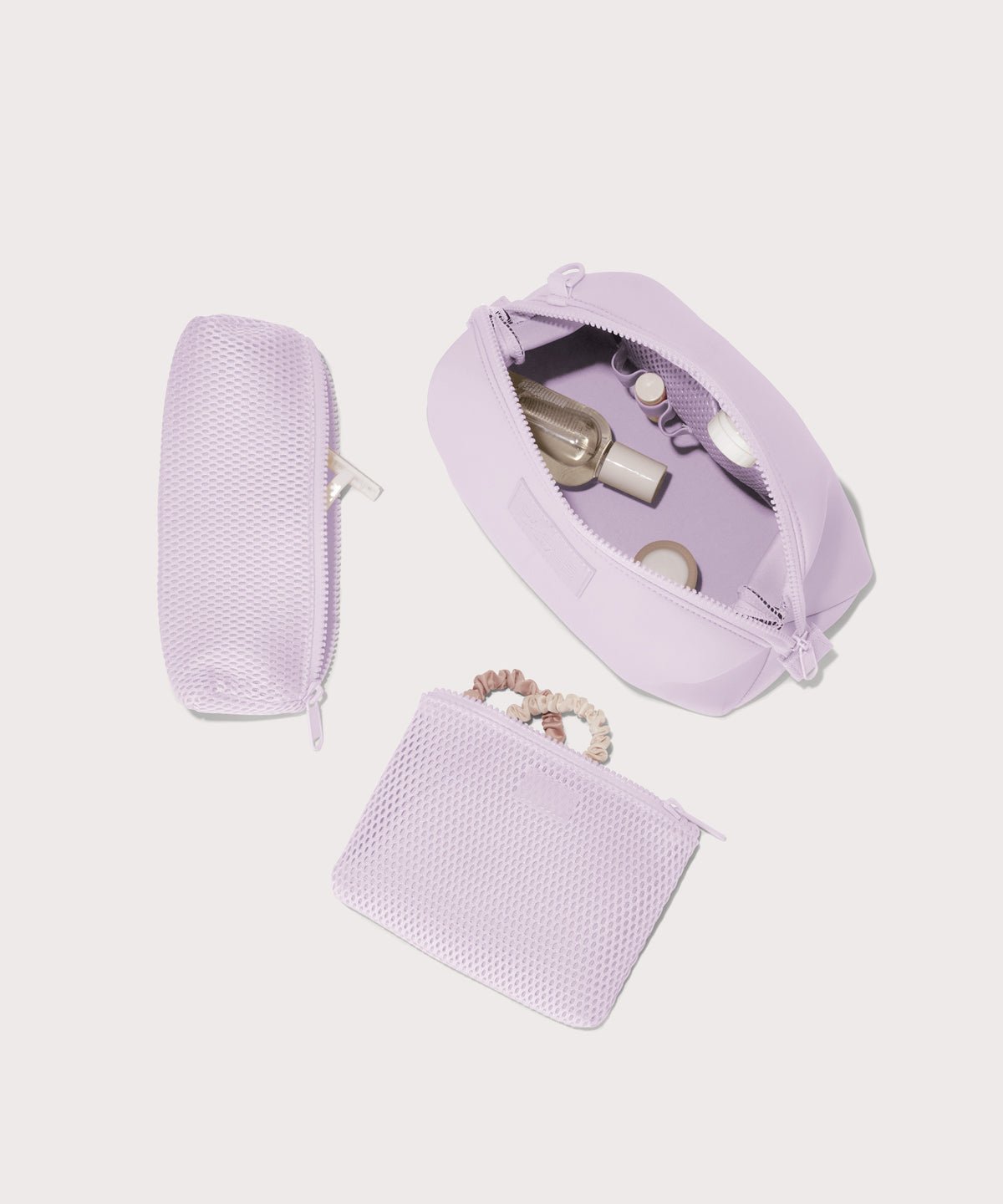 Dagne Dover Large Hunter Toiletry Bag in a soft purple with grey undertones. unzipped and seen from above with the removable air mesh pouch alongside it.