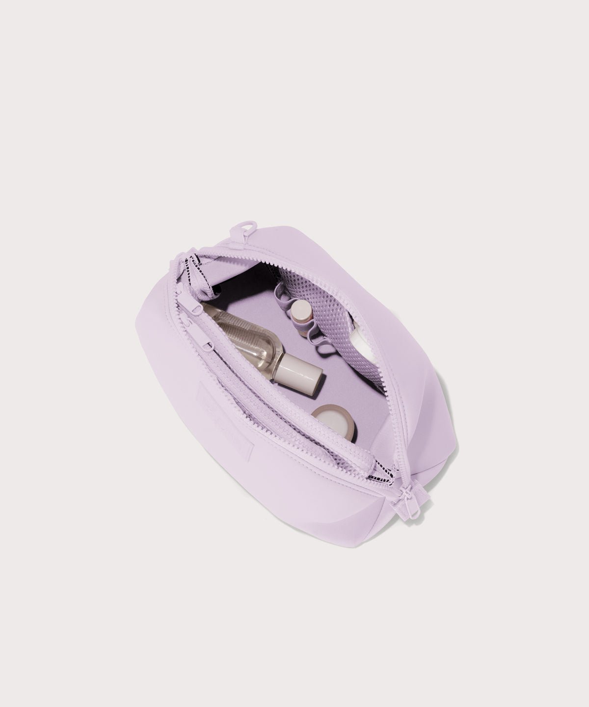 Dagne Dover large Hunter Toiletry Bag in a soft purple with grey undertones unzipped and seen from above.
