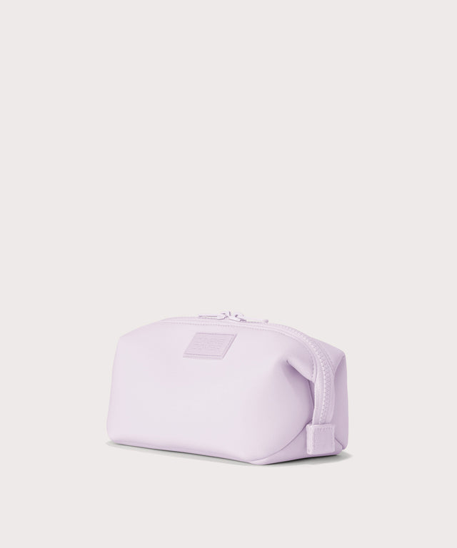 Dagne Dover Small Hunter Toiletry Bag in  a soft purple with grey undertones seen from an angle.
