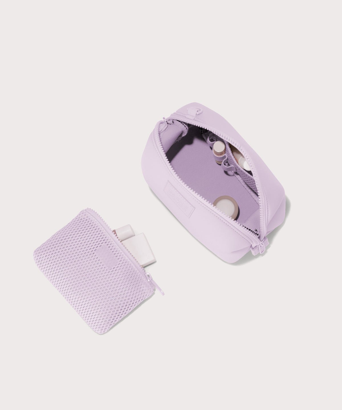 Dagne Dover Small Hunter Toiletry Bag in  a soft purple with grey undertones unzipped and seen from above with the removable air mesh pouch alongside it.