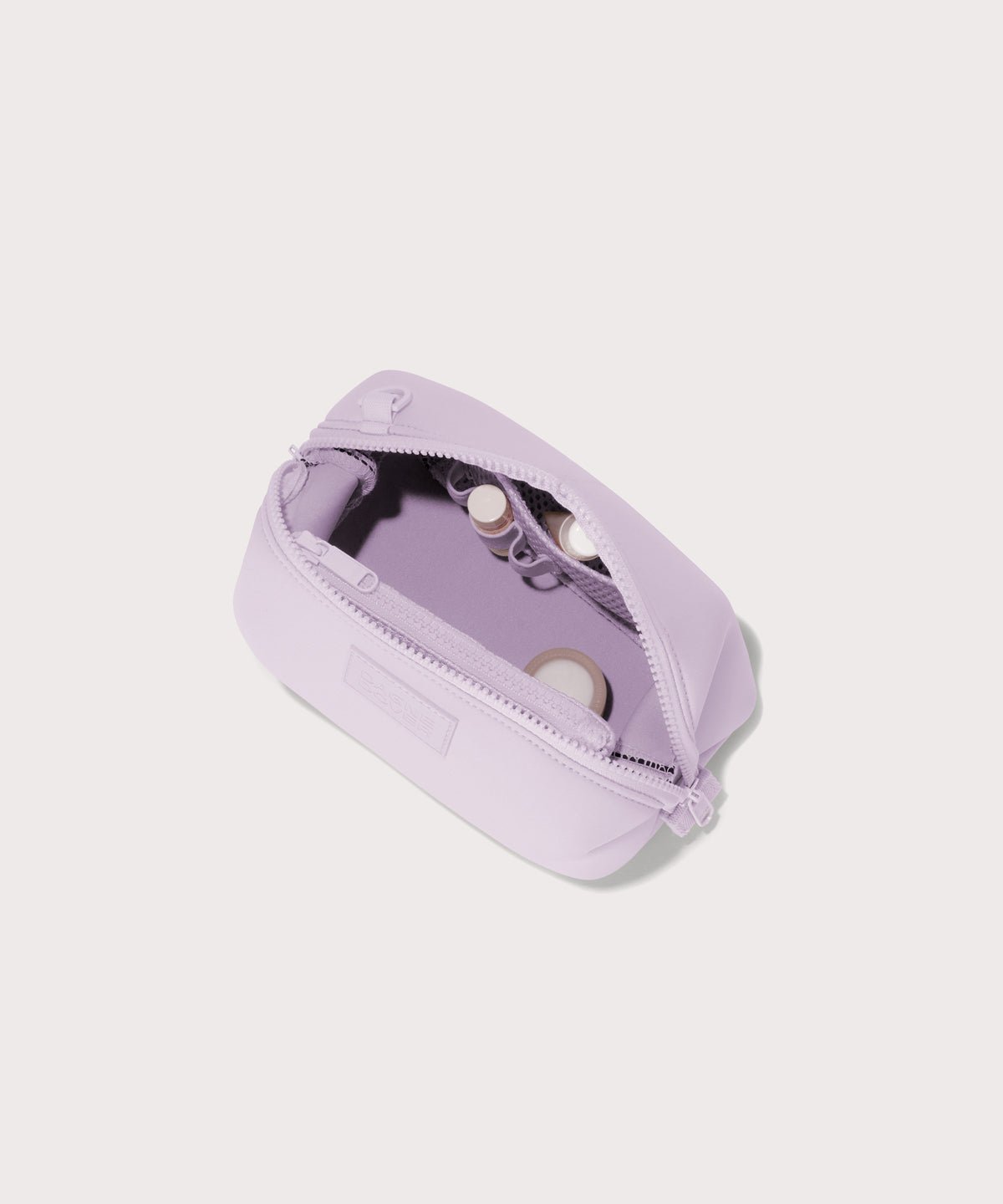 Dagne Dover Small Hunter Toiletry Bag in  a soft purple with grey undertones unzipped and seen from above.
