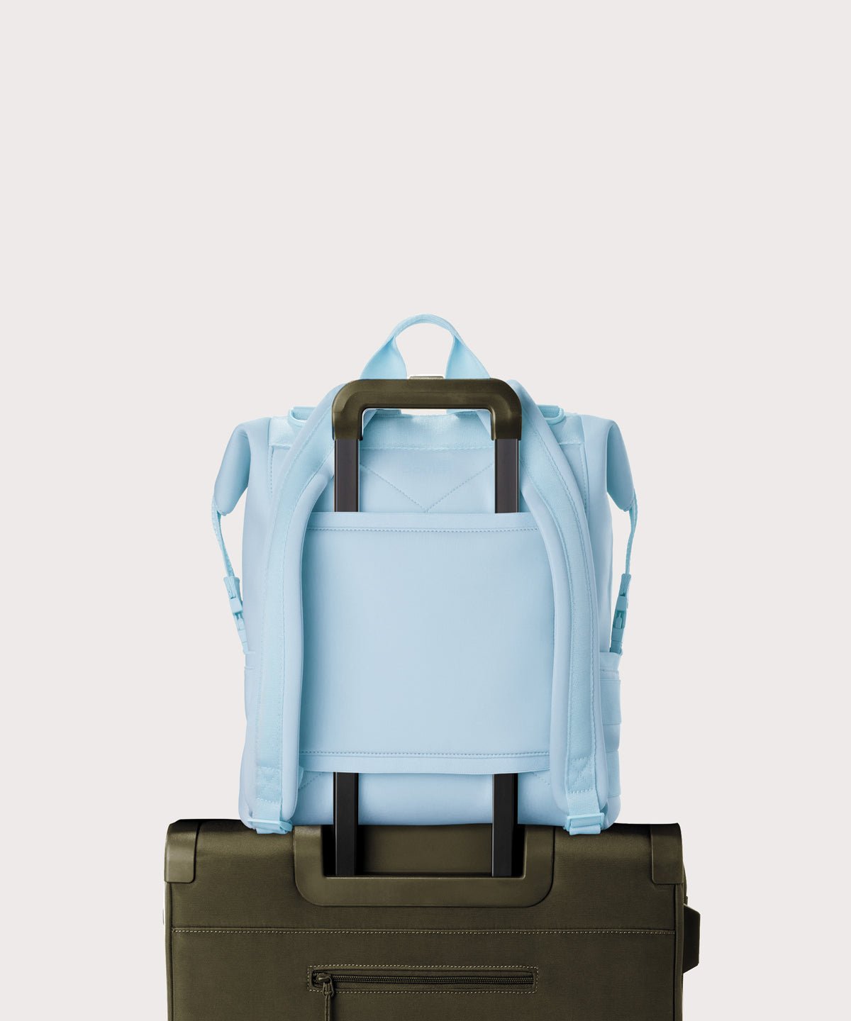 Dagne Dover Large Indi Diaper Backpack in an airy, lighter sky blue showing the neoprene luggage sleeve.
