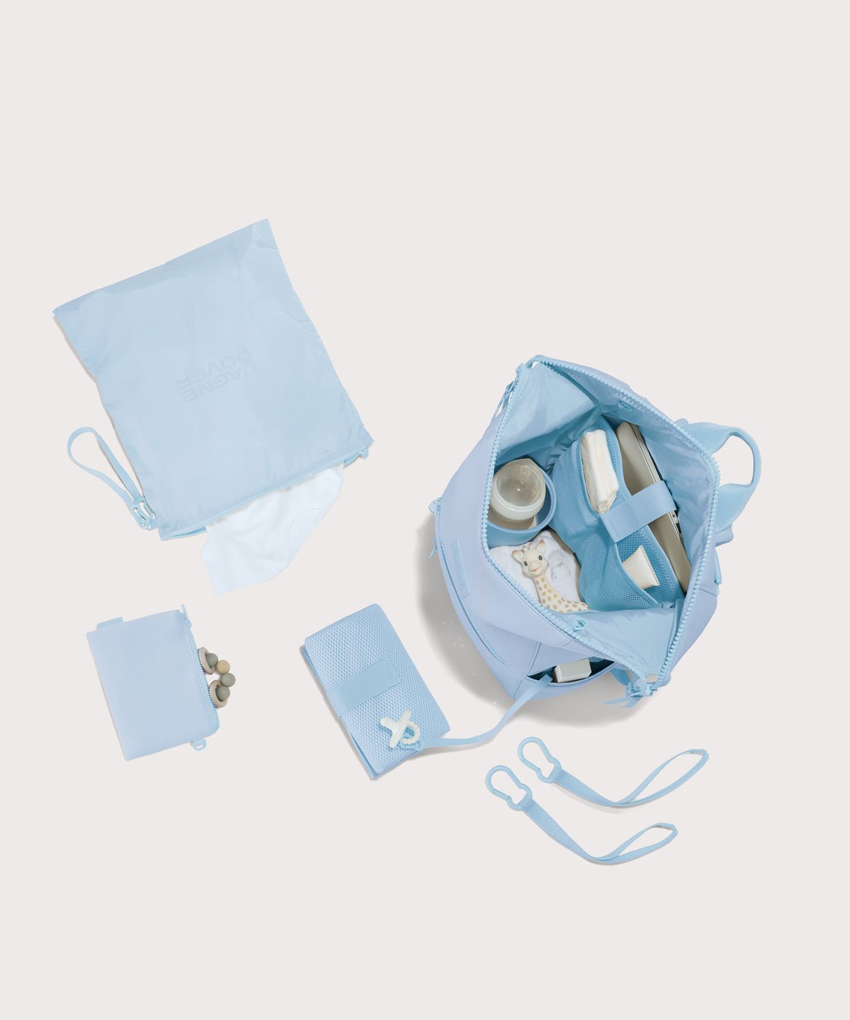 Dagne Dover Large Indi Diaper Backpack in an airy, lighter sky blue showing it's water resistant bag, interior pockets, and changing mat.