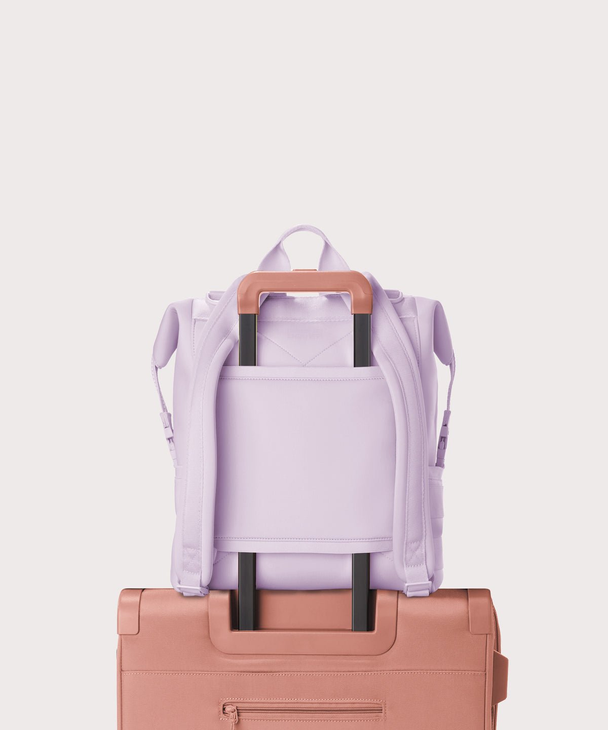 Dagne Dover Large Indi Diaper Backpack in a soft purple with grey undertones showing the neoprene luggage sleeve.