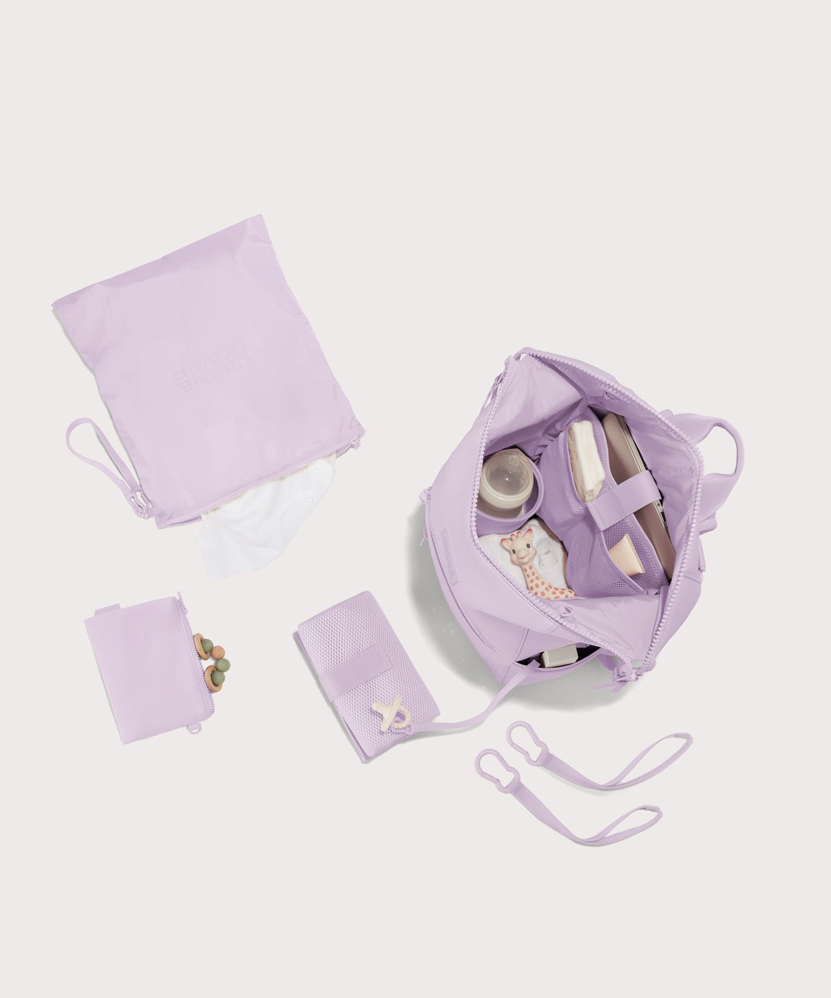Dagne Dover Large Indi Diaper Backpack in a soft purple with grey undertones showing it's water resistant bag, interior pockets, and changing mat.