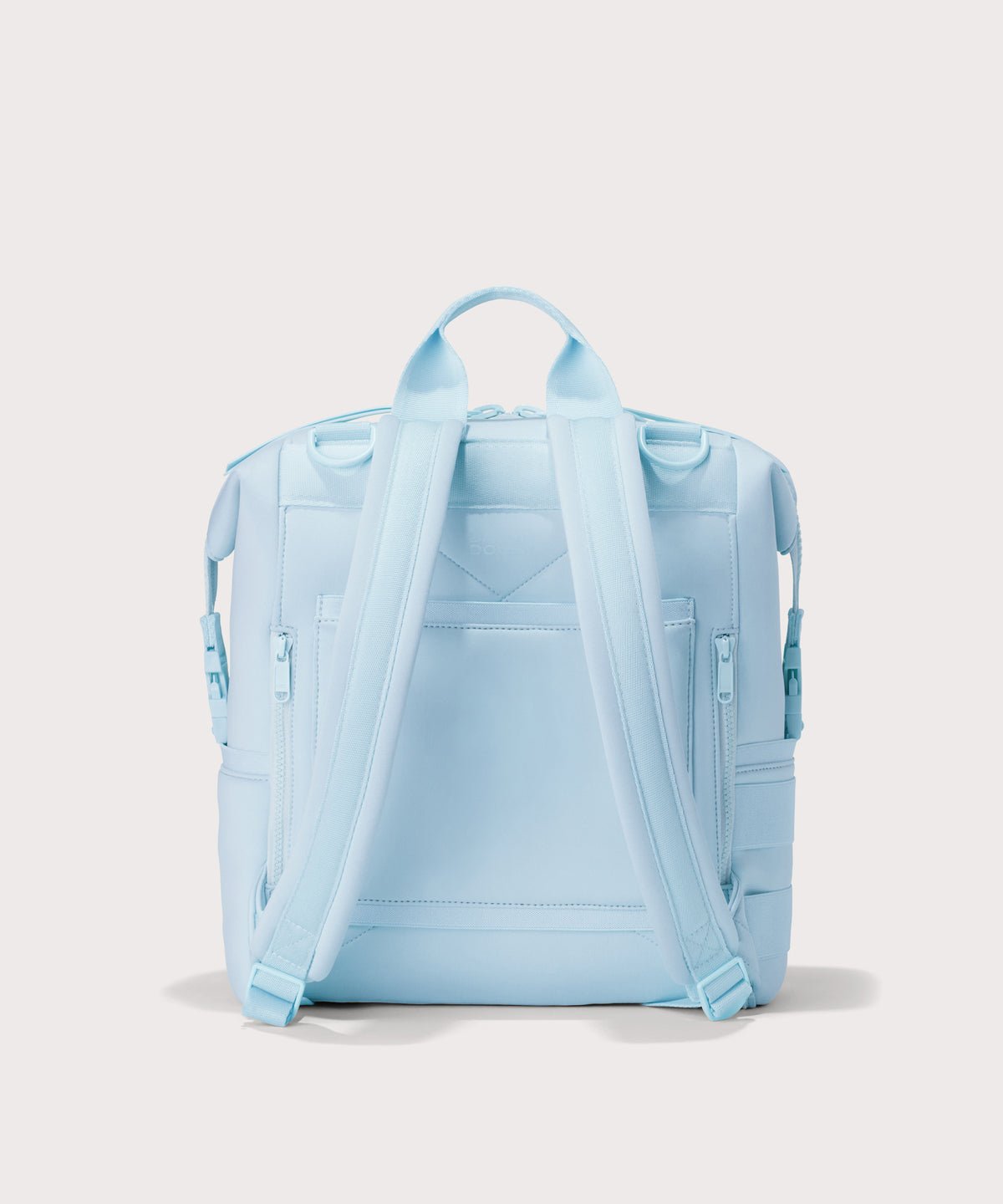 Dagne Dover Medium Indi Diaper Backpack in an airy, lighter sky blue. seen from the back.
