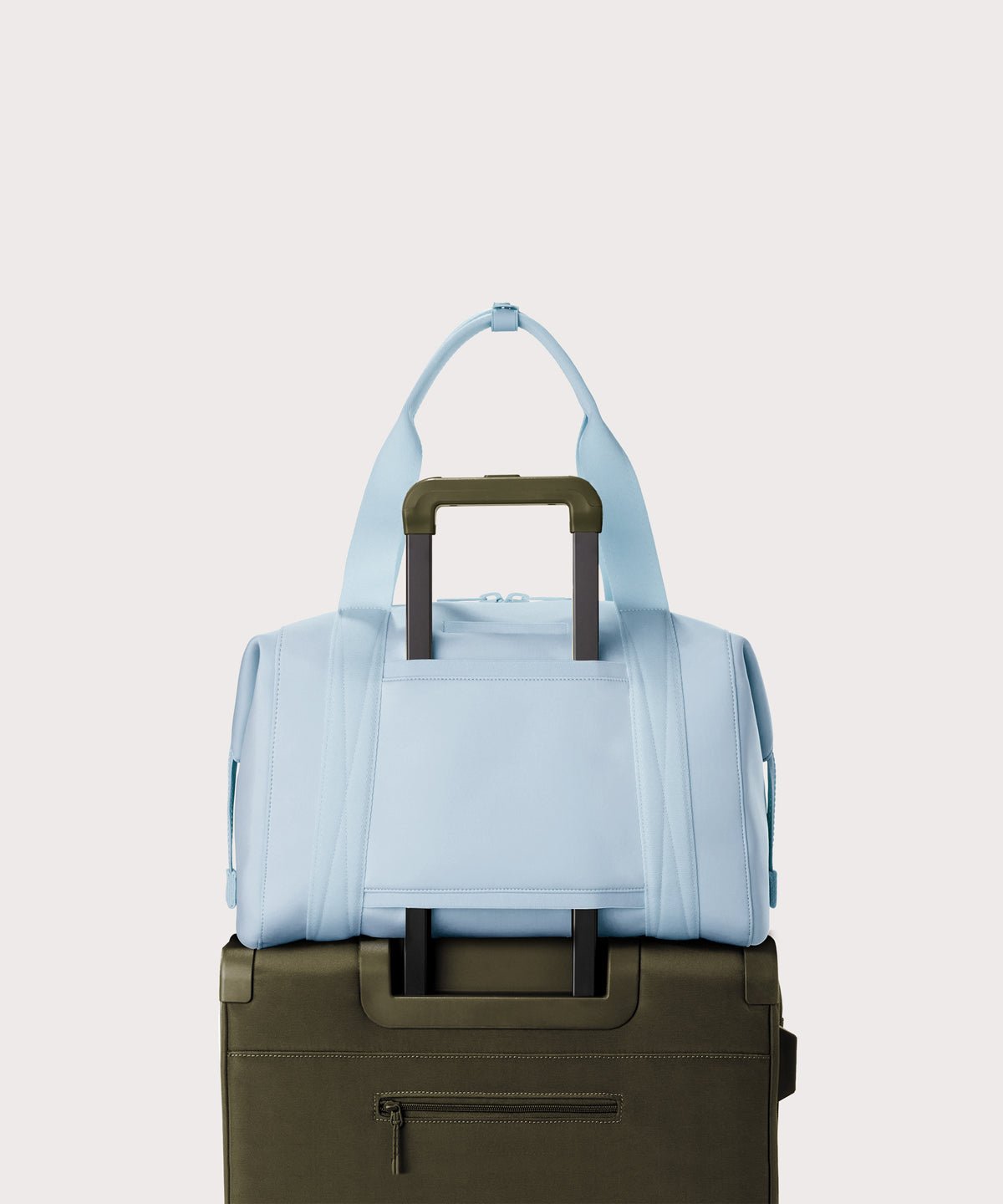 Large Landon Carryall in an airy, lighter sky blue displaying luggage sleeve
