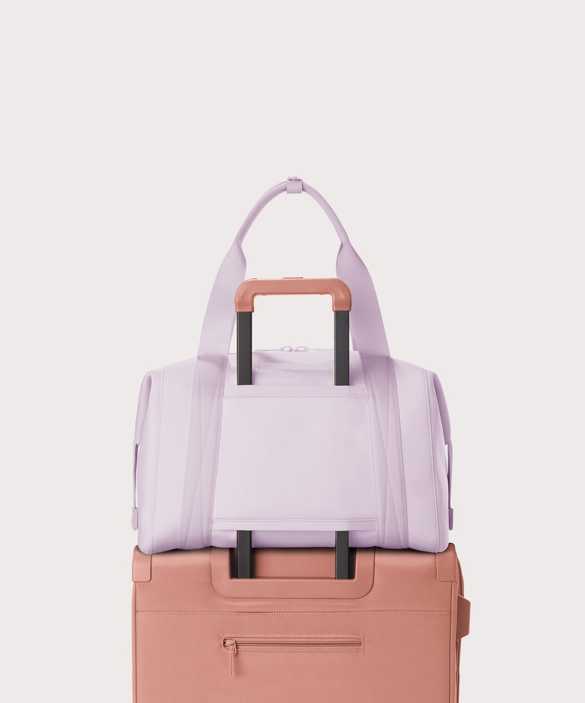 Large Landon Carryall in a soft purple with grey undertones displaying luggage sleeve
