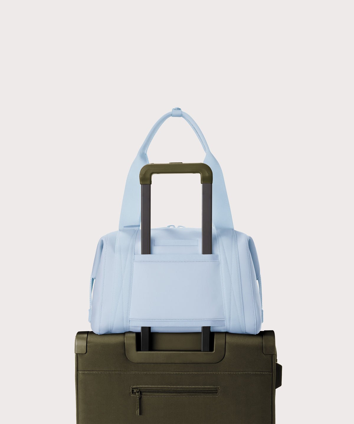 Large Landon Carryall in an airy, lighter sky blue displaying luggage sleeve
