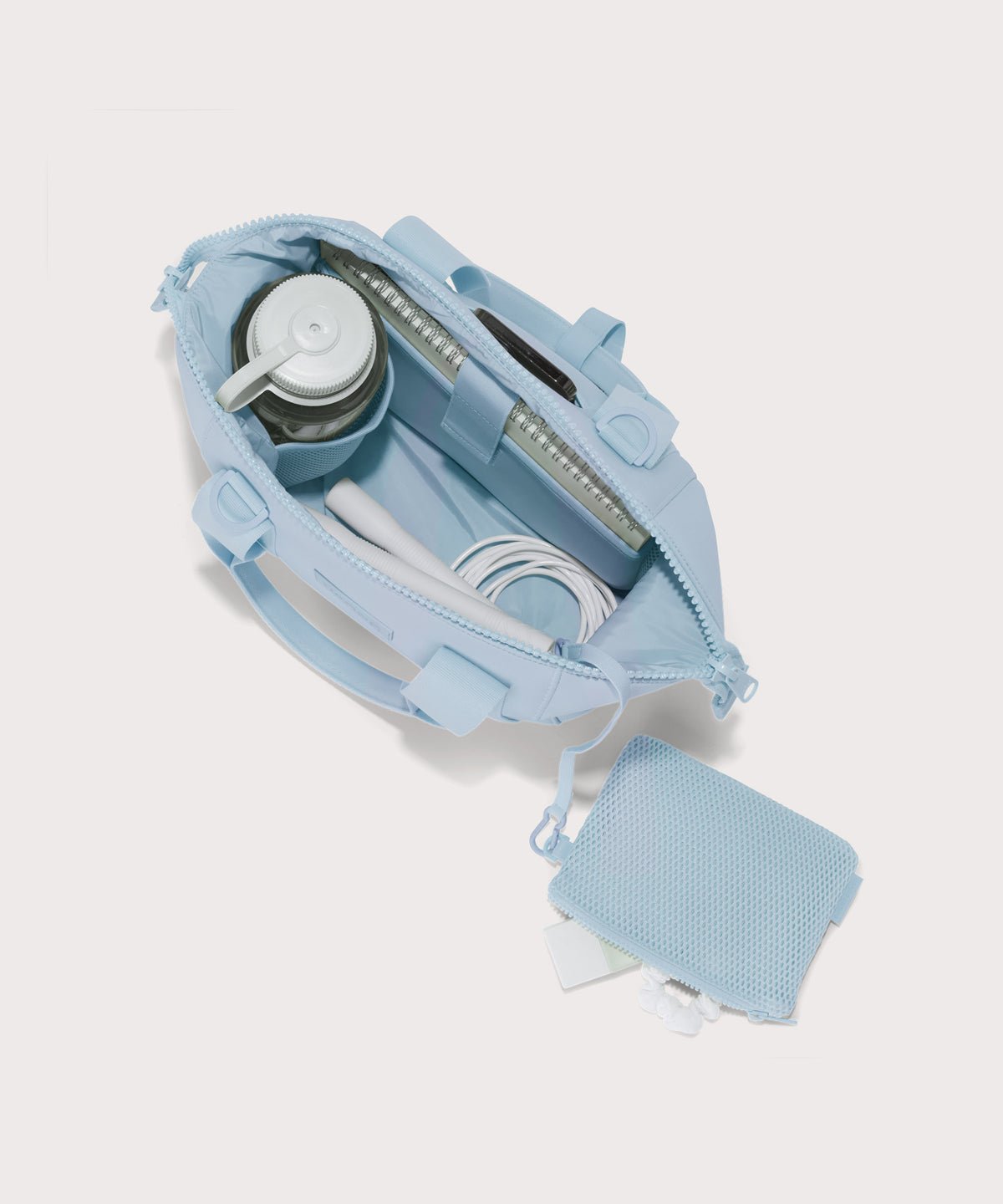 small Landon Carryall in an airy, lighter sky blue unzipped, top down view