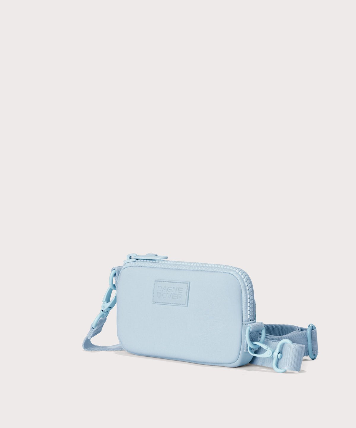 Dagne Dover Mara Phone Sling in an airy, lighter sky blue. seen from an angle, showing the adjustable shoulder strap drop.
