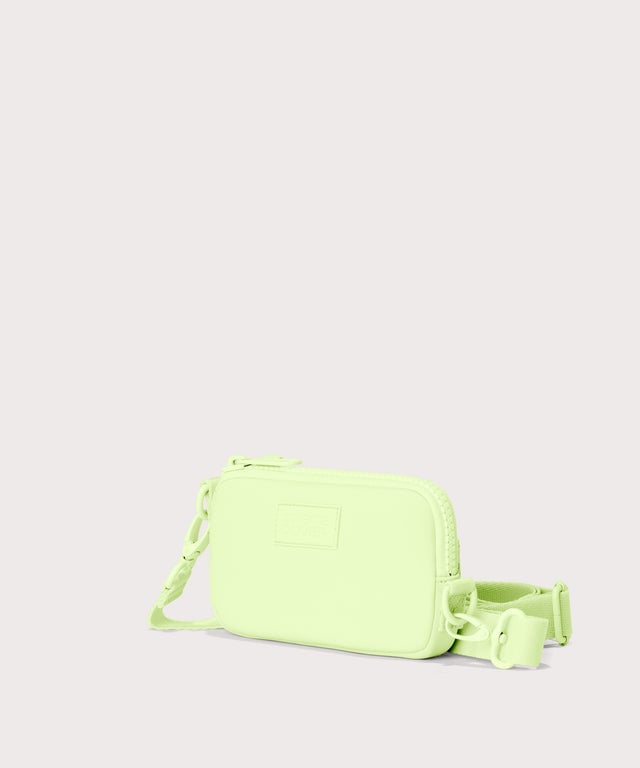 Dagne Dover Mara Phone Sling in matcha seen from an angle, showing the adjustable shoulder strap drop.
