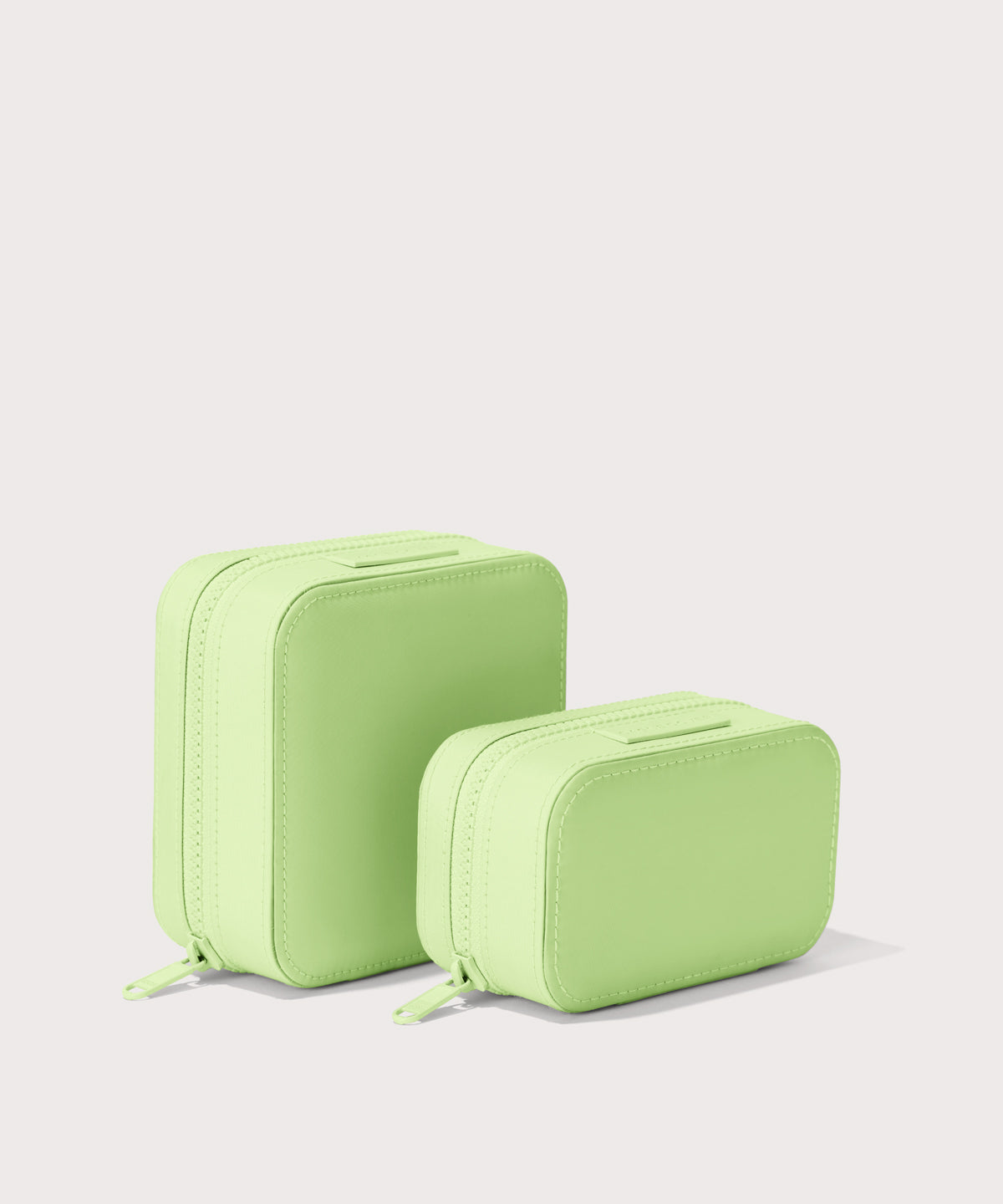 Dagne Dover Small and Large Frankie Jewelry Cases in matcha green standing next to one another.
