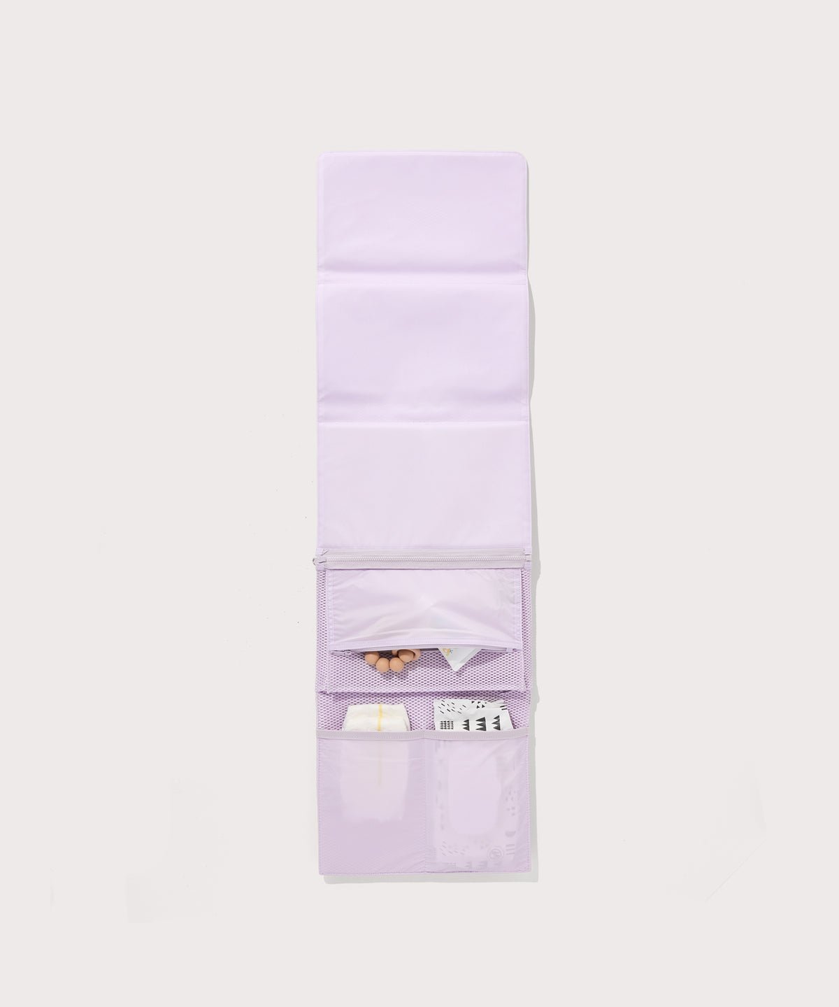 Dagne Dover Joey Changing Kit in  a soft purple with grey undertones unfolded, revealing the interior zipper pocket and interior slip pockets.
