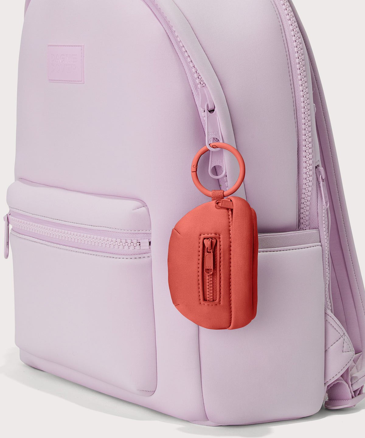 Dagne Dover Ace Keychain in a poppy, vintage wash red clipped onto a backpack