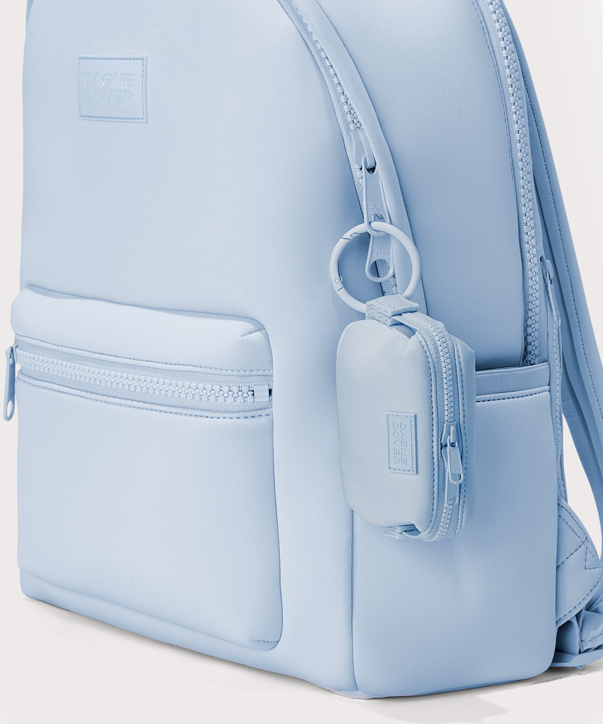Dagne Dover Hunter Keychain in an airy, lighter sky blue clipped onto a backpack. 