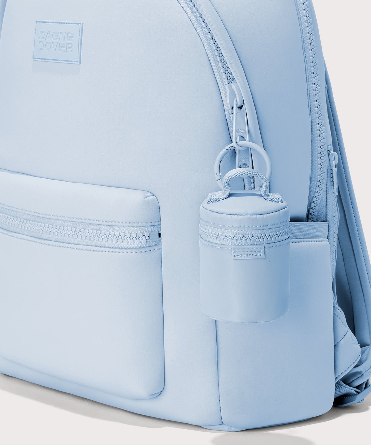 Dagne Dover Mila Keychain in a an airy, lighter sky blue seen on a backpack.
