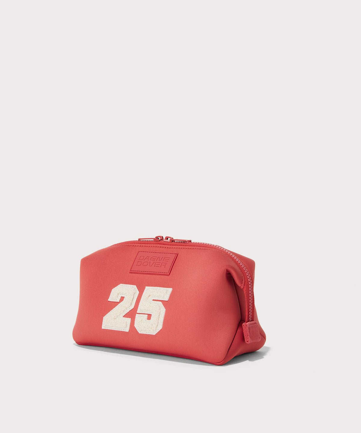 Dagne Dover large Hunter Toiletry Bag in a poppy, vintage wash red seen from an angle.

