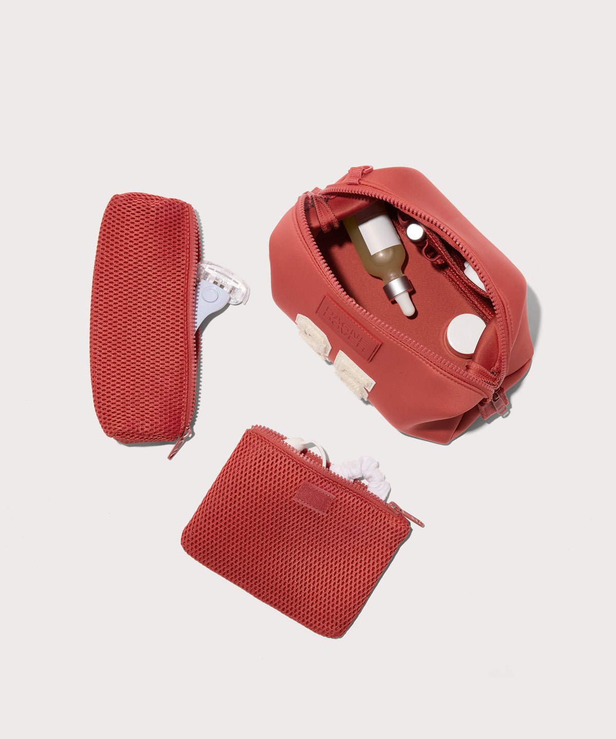 Dagne Dover Large Hunter Toiletry Bag in a poppy, vintage wash red. unzipped and seen from above with the removable air mesh pouch alongside it.