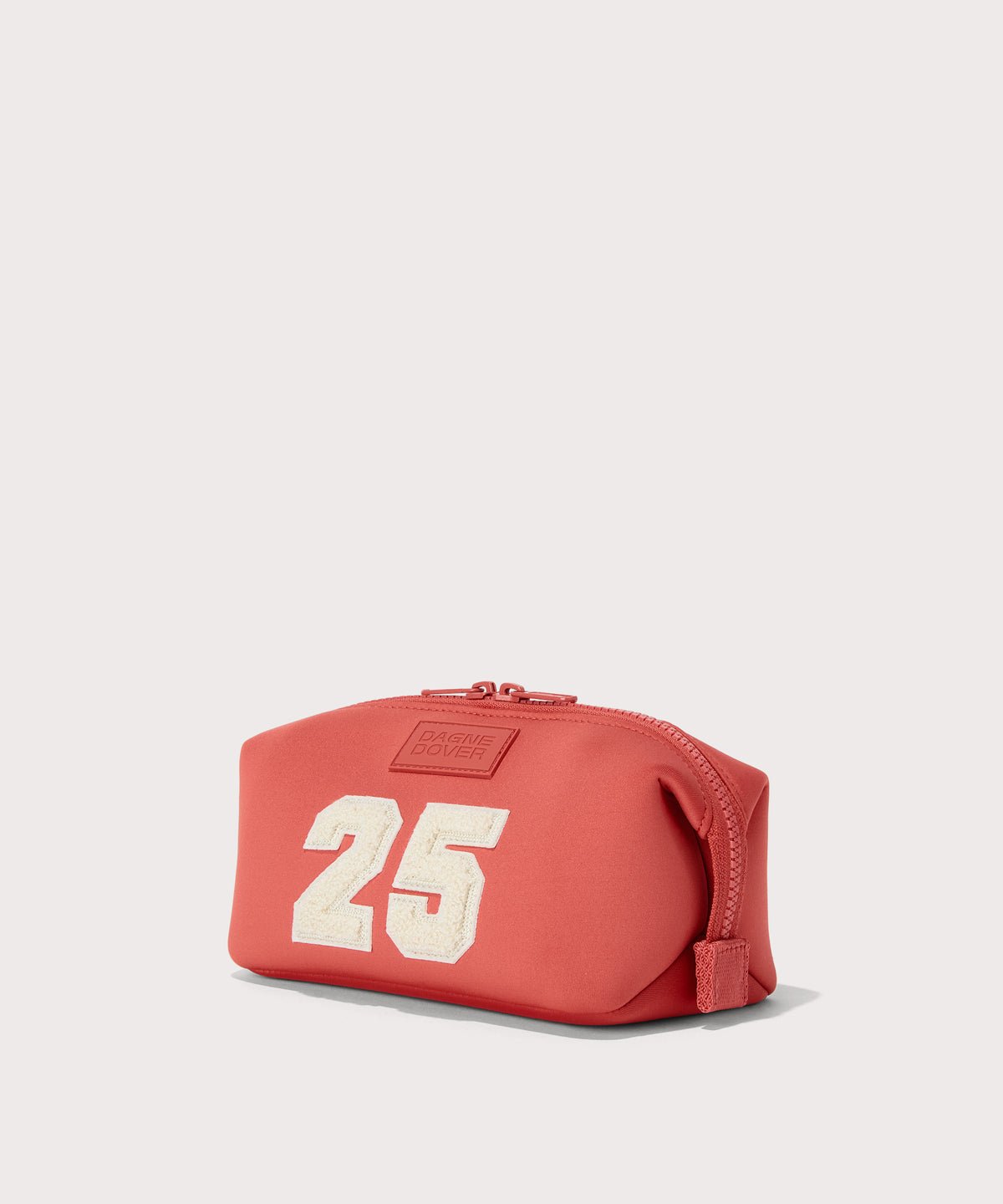 Dagne Dover Small Hunter Toiletry Bag in a poppy, vintage wash red seen from an angle.
