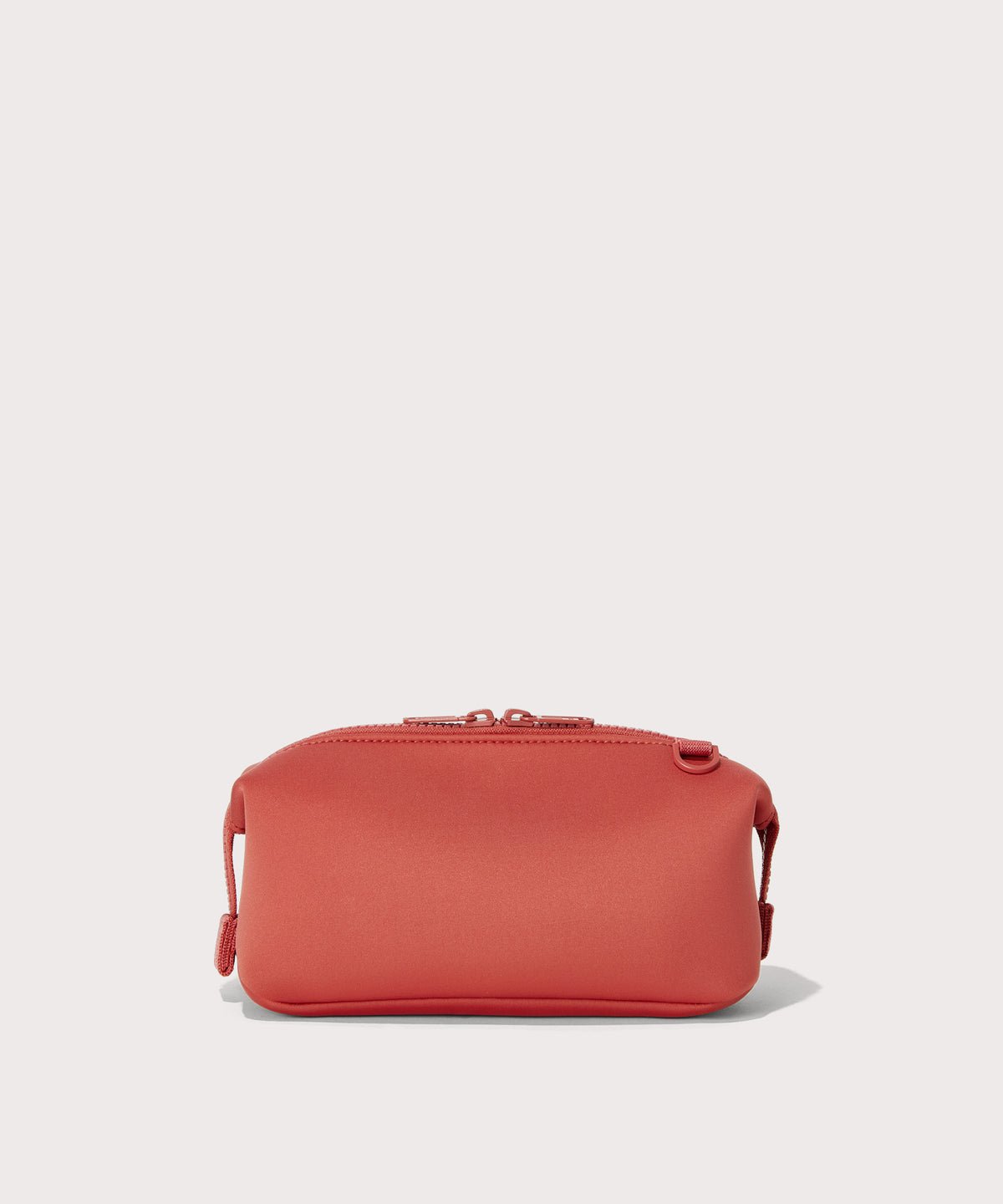 Dagne Dover Small Hunter Toiletry Bag in a poppy, vintage wash red seen from the back.
