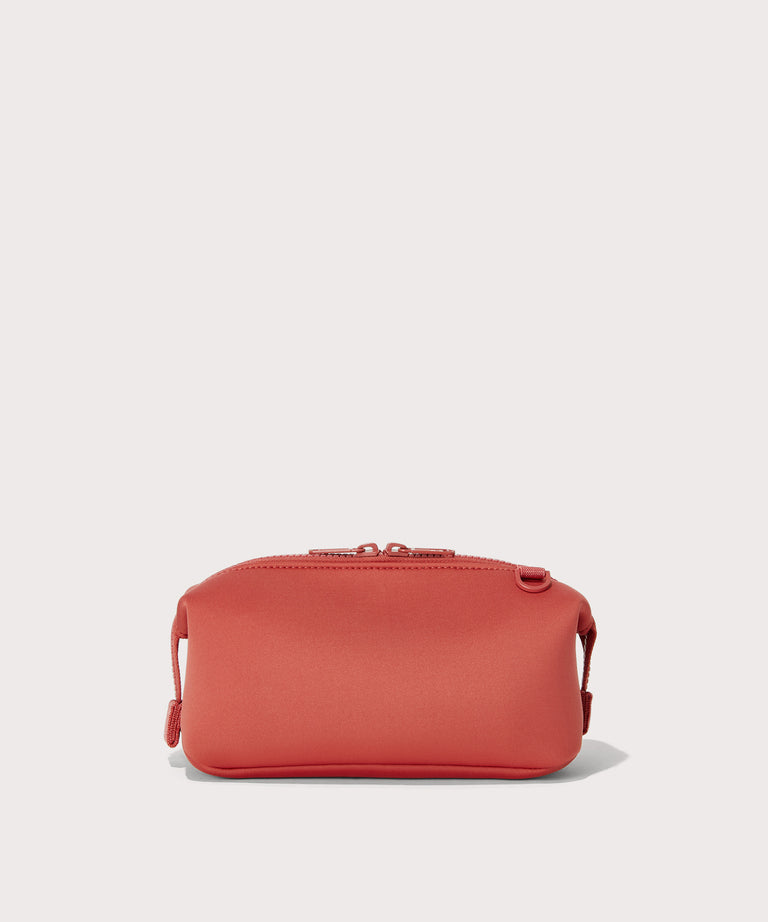 Dagne Dover Small Hunter Toiletry Bag in a poppy, vintage wash red seen from the back.
