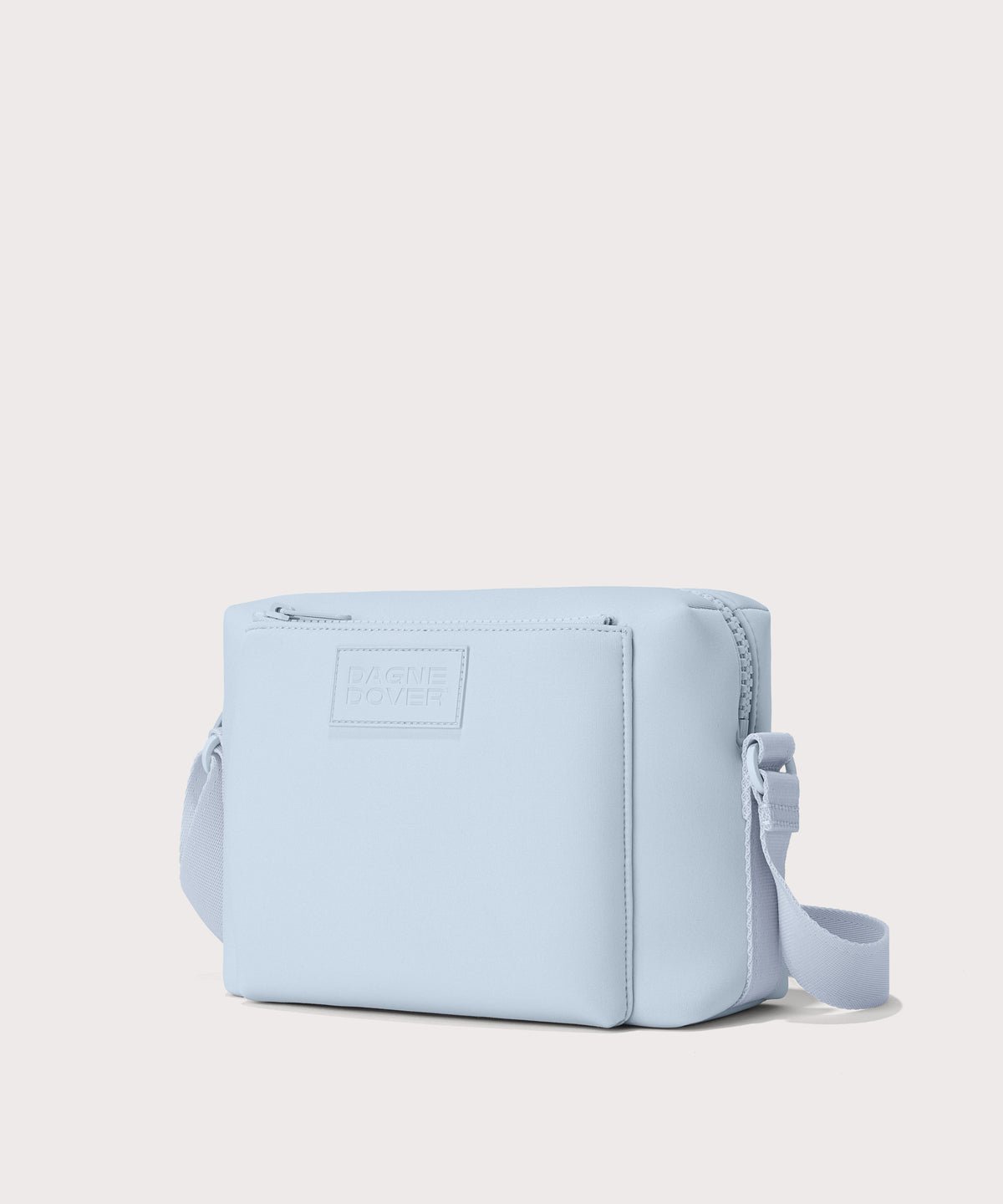 Dagne Dover Micah crossbody in an airy, lighter sky blue seen from an angle.
