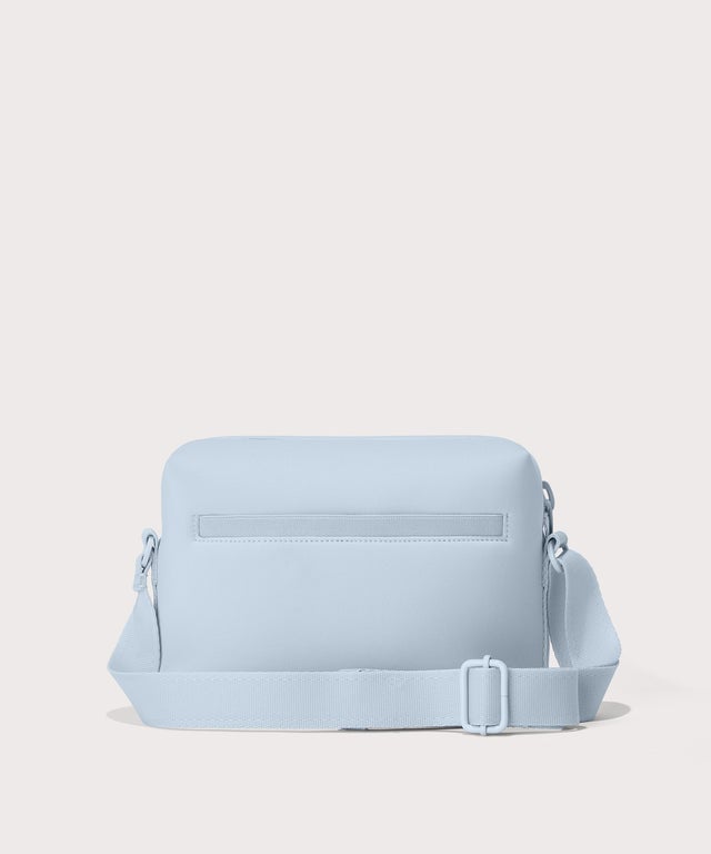 Dagne Dover Micah Crossbody in an airy, lighter sky blue seen from the back.
