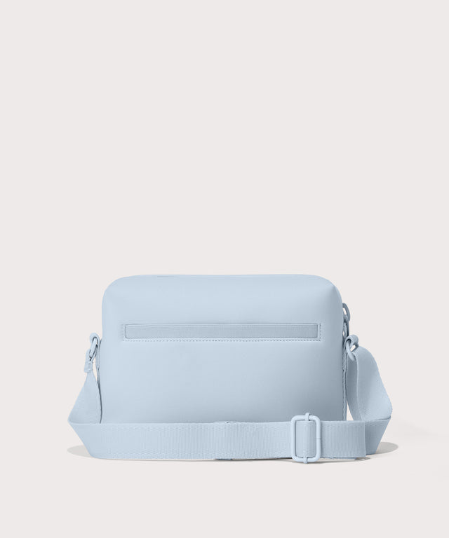 Dagne Dover Micah Crossbody in an airy, lighter sky blue seen from the back.
