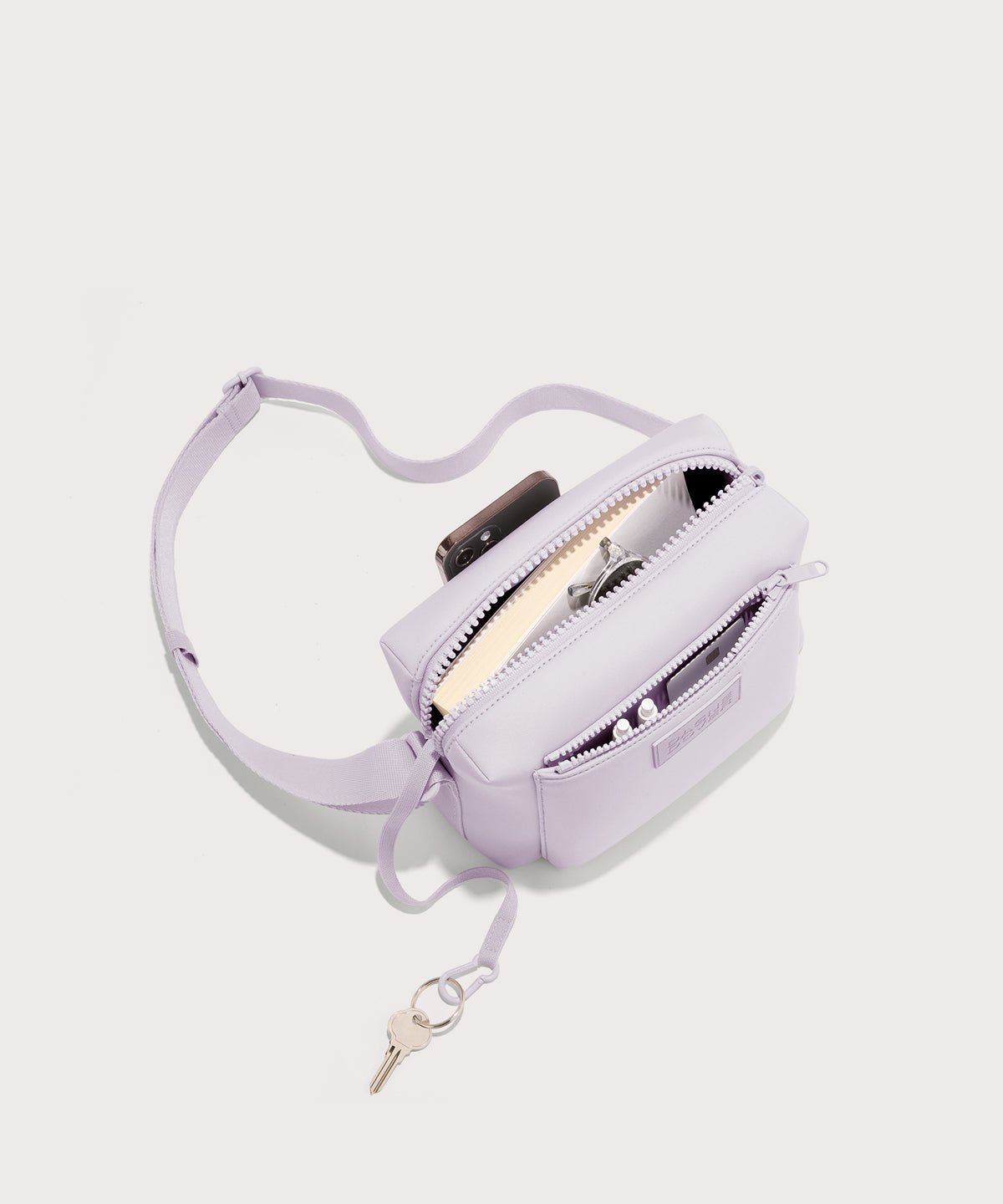 Dagne Dover Micah Crossbody in a soft purple with grey undertones seen from above, showing the interior air mesh pocket.