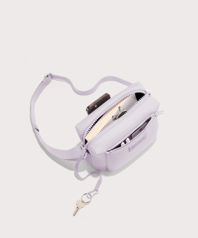 Dagne Dover Micah Crossbody in a soft purple with grey undertones seen from above, showing the interior air mesh pocket.