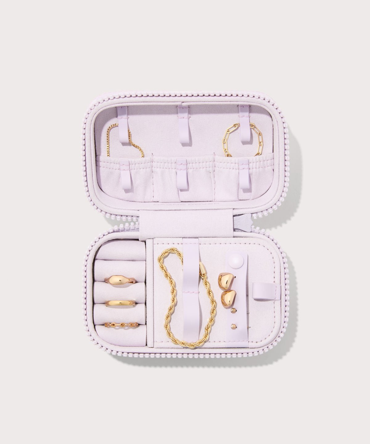 Dagne Dover small Frankie Jewelry Case in a custom washed lilac and cream floral print, seen open from above with jewelry inside the interior compartment.