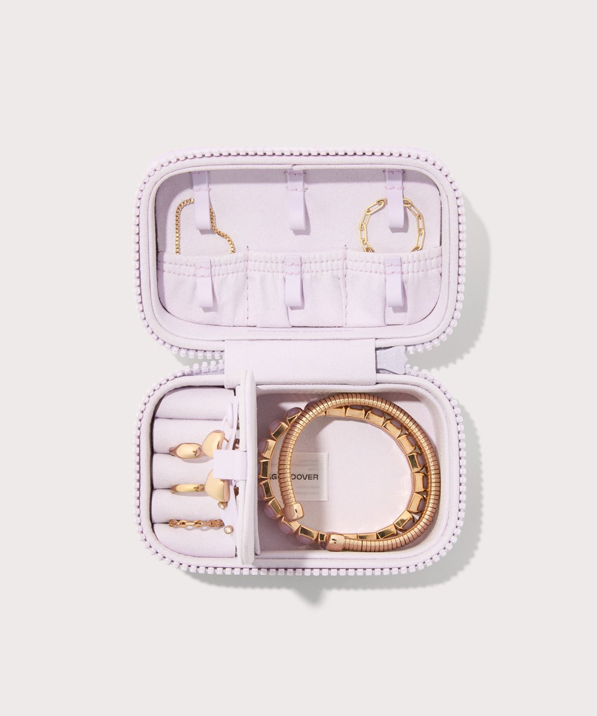 Dagne Dover small Frankie Jewelry Case in a custom washed lilac and cream floral print, seen open from above with jewelry inside the interior compartment.