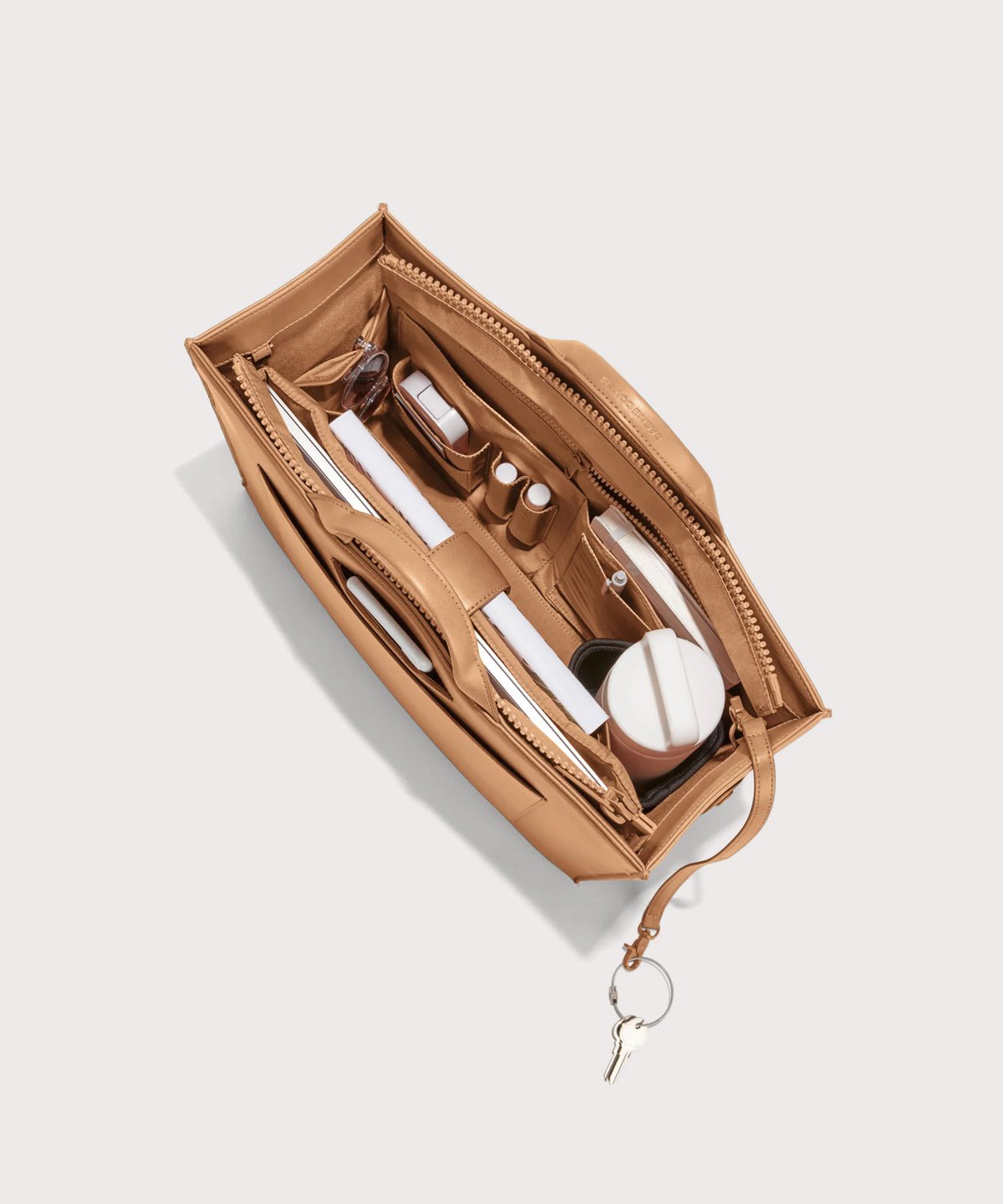Dagne Dover large vegan Daily Tote in brown from above, revealing the interior zipper, interior slip pockets, and padded laptop sleeve.