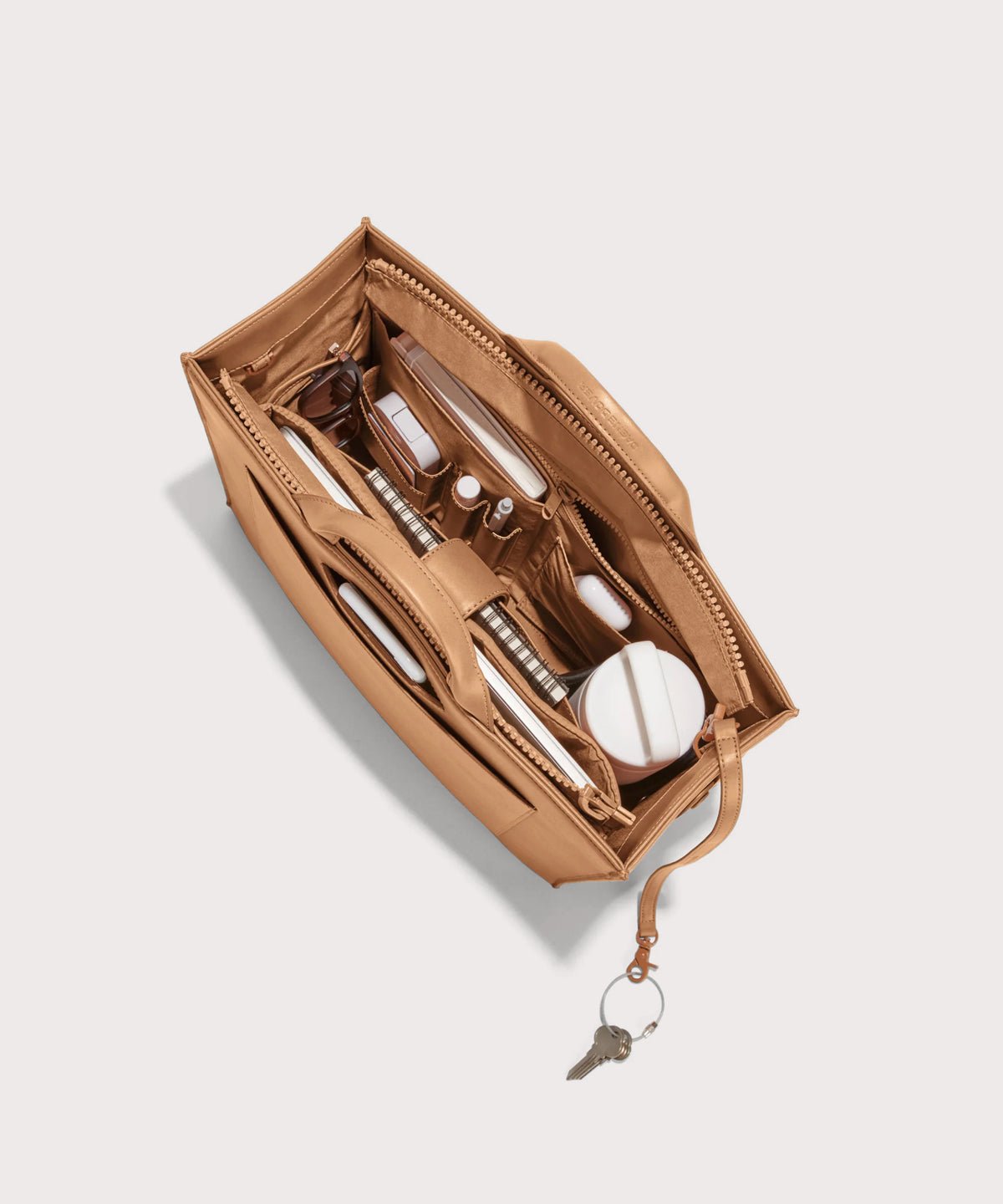 Dagne Dover medium vegan Daily Tote in brown from above, revealing the interior zipper, interior slip pockets, and padded laptop sleeve