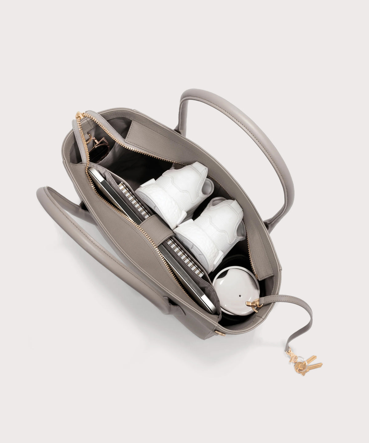 Dagne Dover Legend Signature Leather Tote in beige seen from above, revealing 2 slip pockets, the neoprene bottle holder, and large interior zipper pocket.