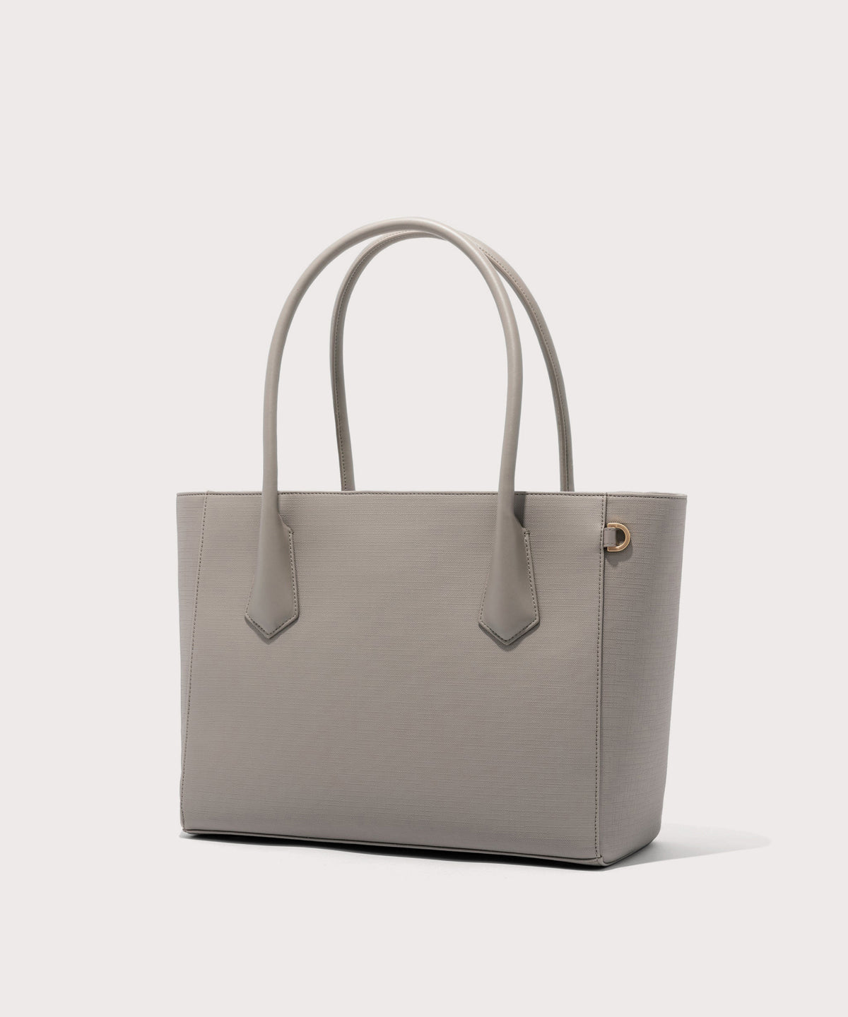 Dagne Dover Legend Signature Leather Tote in beige seen from an angle.

